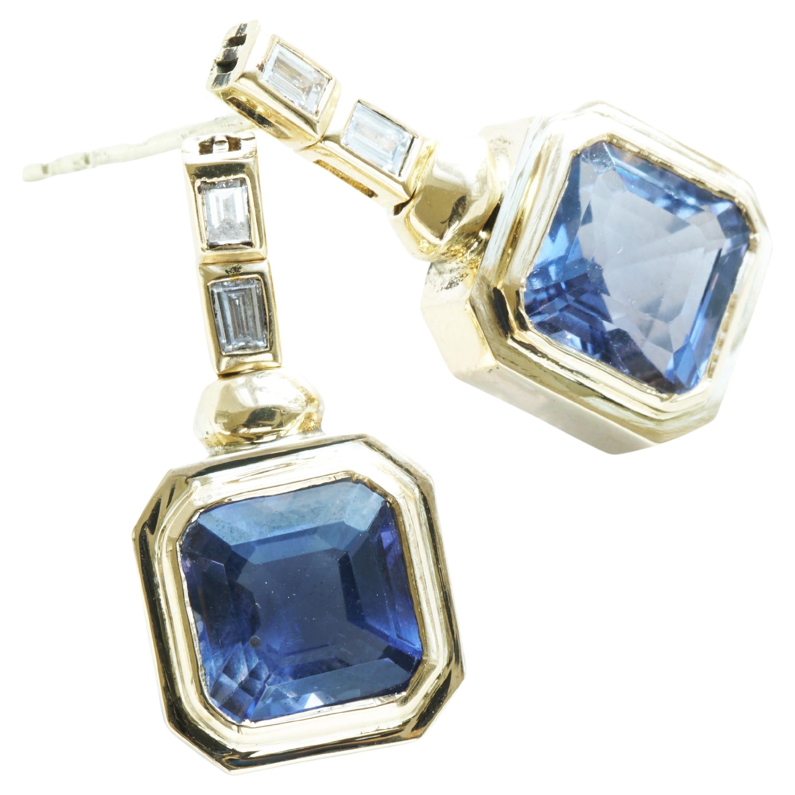 ....Iolite in XXL size, approx. 6.50 ct, rectangular cut, in box setting, pendant (23 x 11 mm ), in 750 yellow gold, 4 diamond baguettes total approx. 0.44 ct, TW / VVS, handcrafted by Juwelier Kröpfl in Zell am See (Austria), weighing approx. 5
