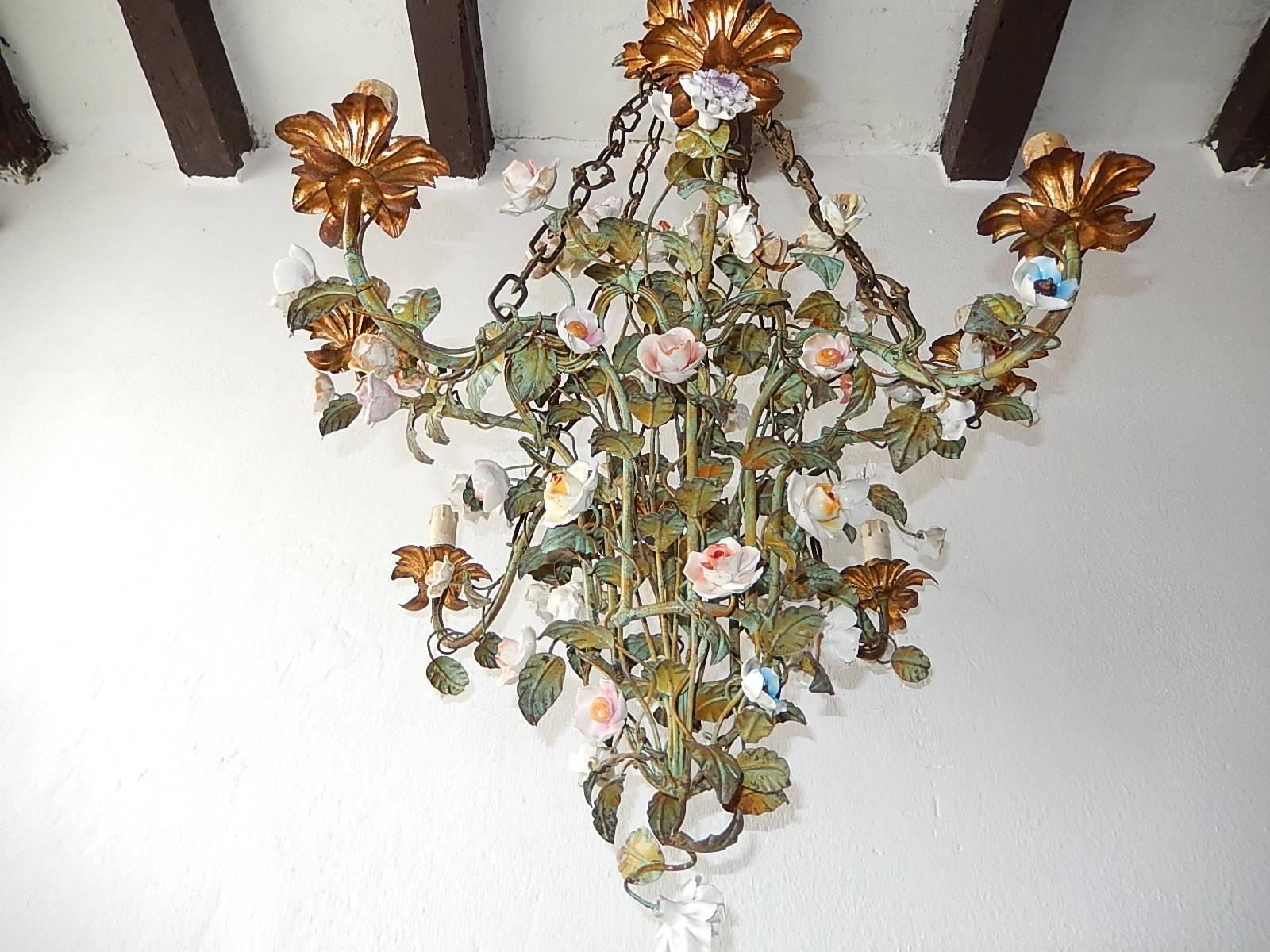 Housing eight lights. Rewired and ready to hang. Tole leaves. Gold gilded bulb holders and canopy. Handmade porcelain flowers and in tole as well.