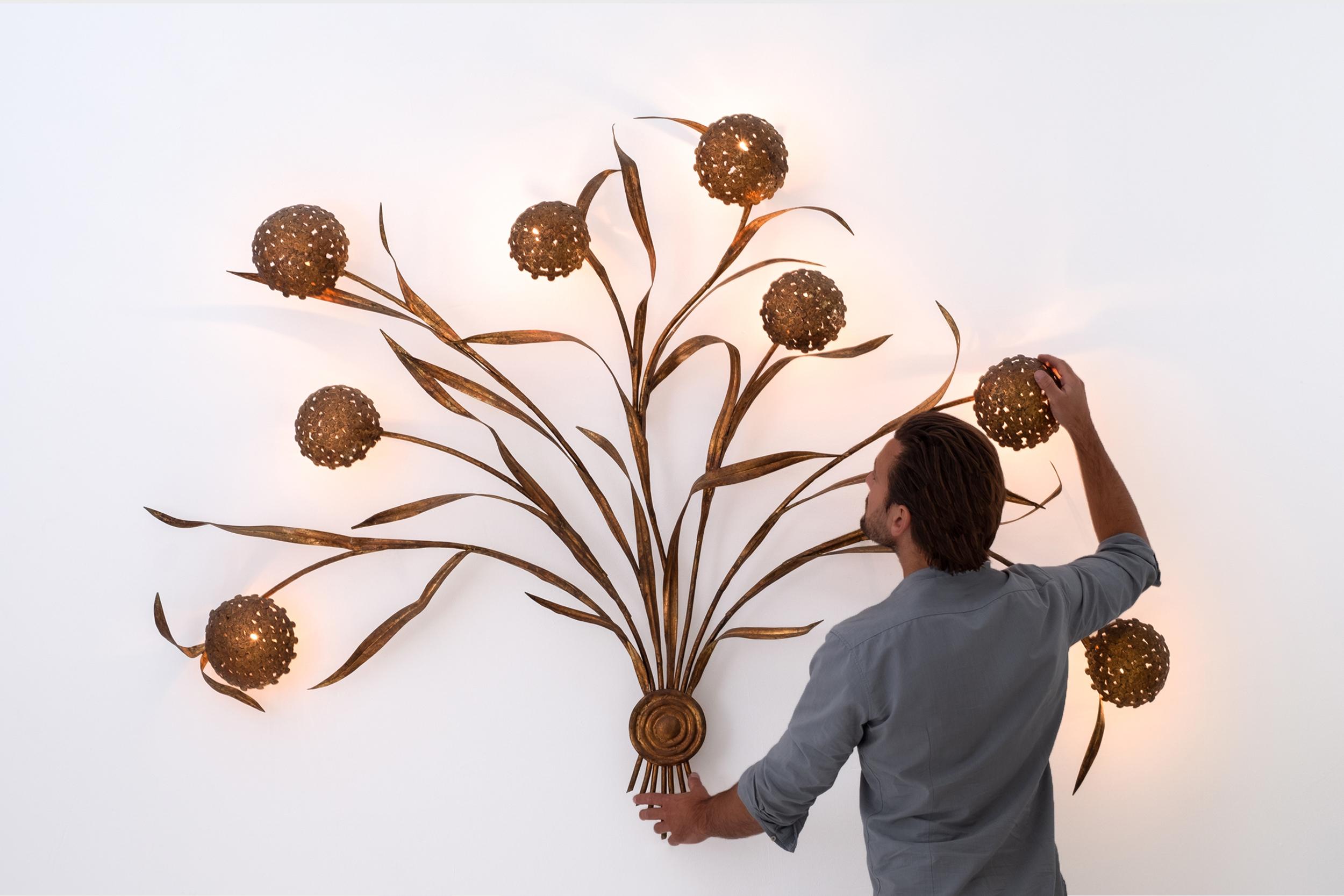 Huge Italian Mid-Century Modern gilded wheat leaves wall lamp, Italy 1950s.
The enormous leaves and flowers are made from Gilded metal, all handmade. Each flower ball hides a light socket, means 8 light sockets in total. The lamp comes from an old