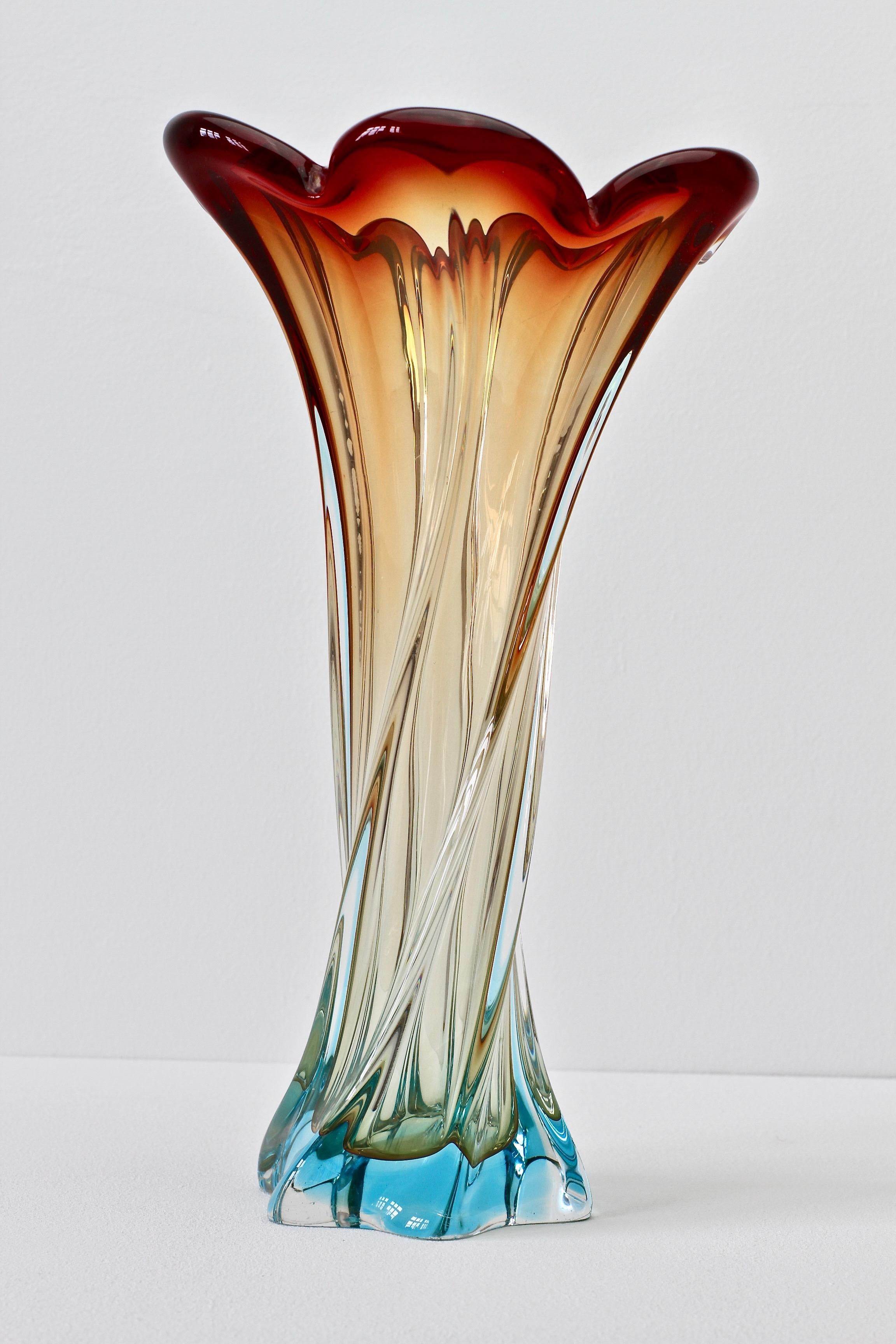 A wonderful and tall Murano style vase of maroon, amber and blue Sommerso glass. This piece is huge at almost twelve inches tall. A wonderful statement piece and would look exceptional as a centrepiece filled with beautiful flowers or on display on