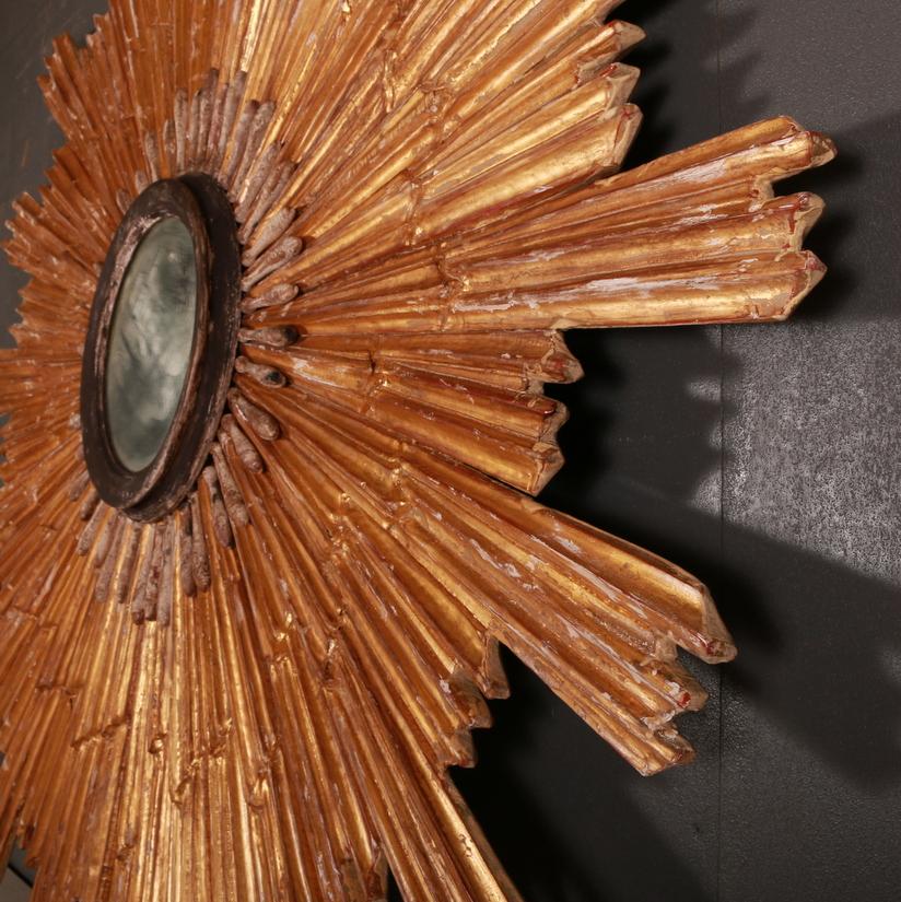 Early 20th century Italian Neoclassic style sunburst wall mirror measuring 5 feet 8 inch's in diameter. Circa 1920

(The sideboard in the photo is for scale and not including in the sale. The sideboard measures 7ft wide)

Reference: