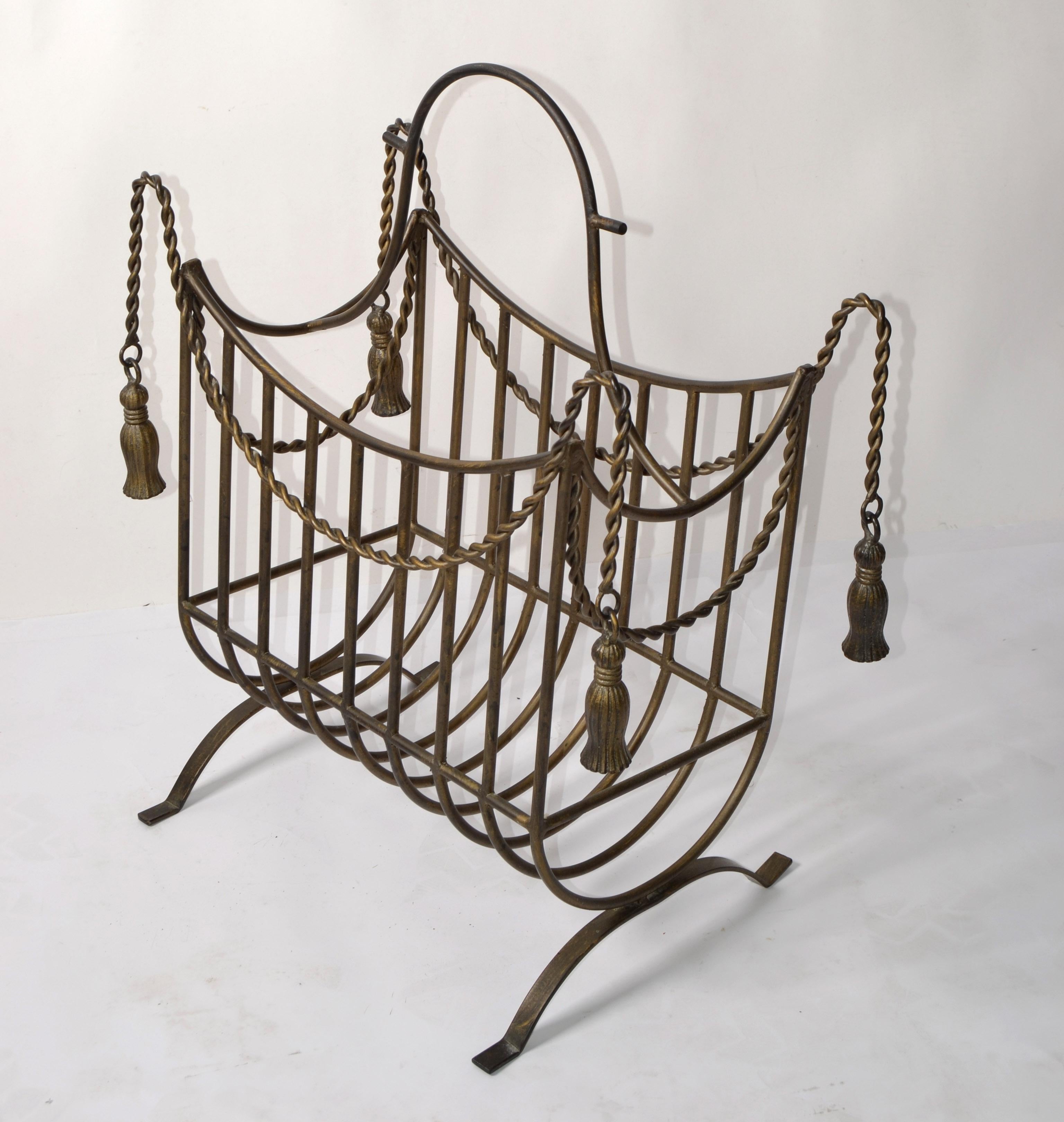 Large Magazine Rack in the Style of Maison Jansen in Wrought Iron hand-crafted in detailed Braided Rope and Tassels Design.
Made in Italy in the late 1960 for heavy Books, Magazines, Atlas, Dictionary and Cookbooks.
The gold finish on the Wrought