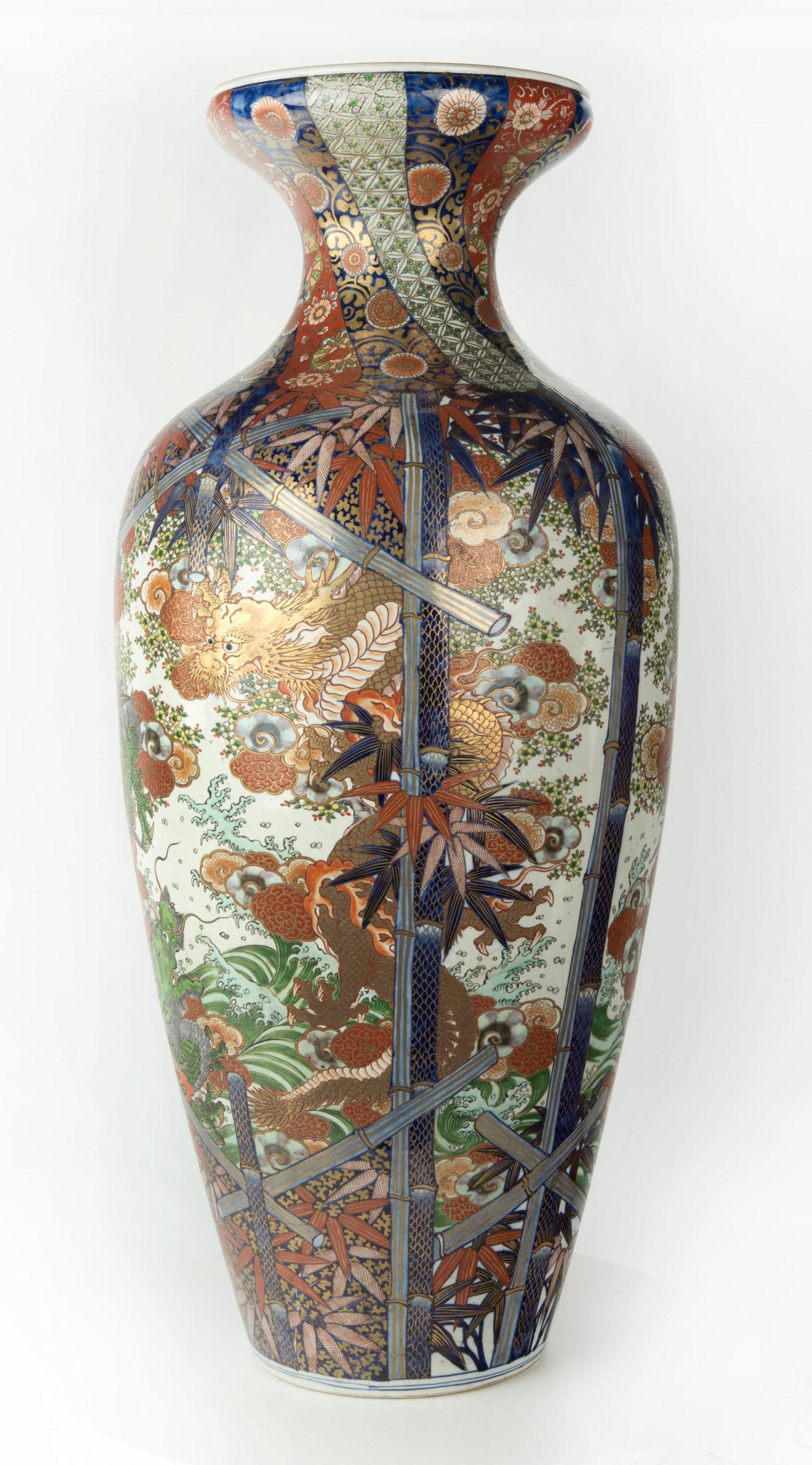 As part of our Japanese works of art collection we are delighted to offer this impressive floor standing Meiji Period 1868-1912 ceramic vase decorated in traditional Imari palette, the sumptuous decoration consists of a pair of opposing dragons