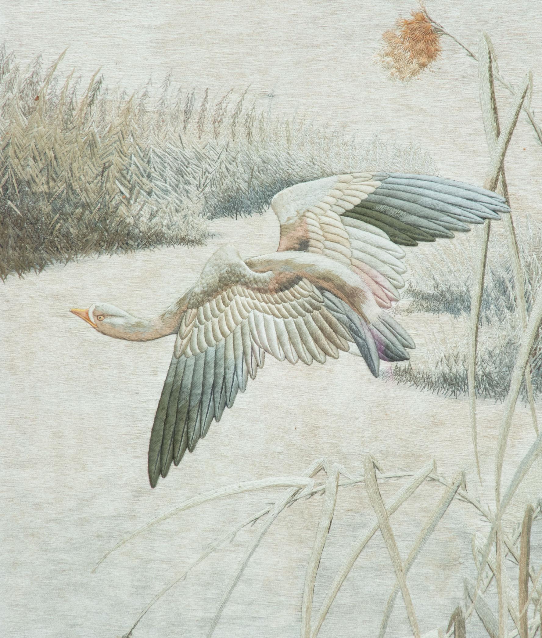 As part of our Japanese works of art collection we are delighted to offer this large scale framed Meiji Period (1868-1912) signed silk textile, the Kyoto artist has rendered a very large scale textile of a goose in flight above a lakeside setting,