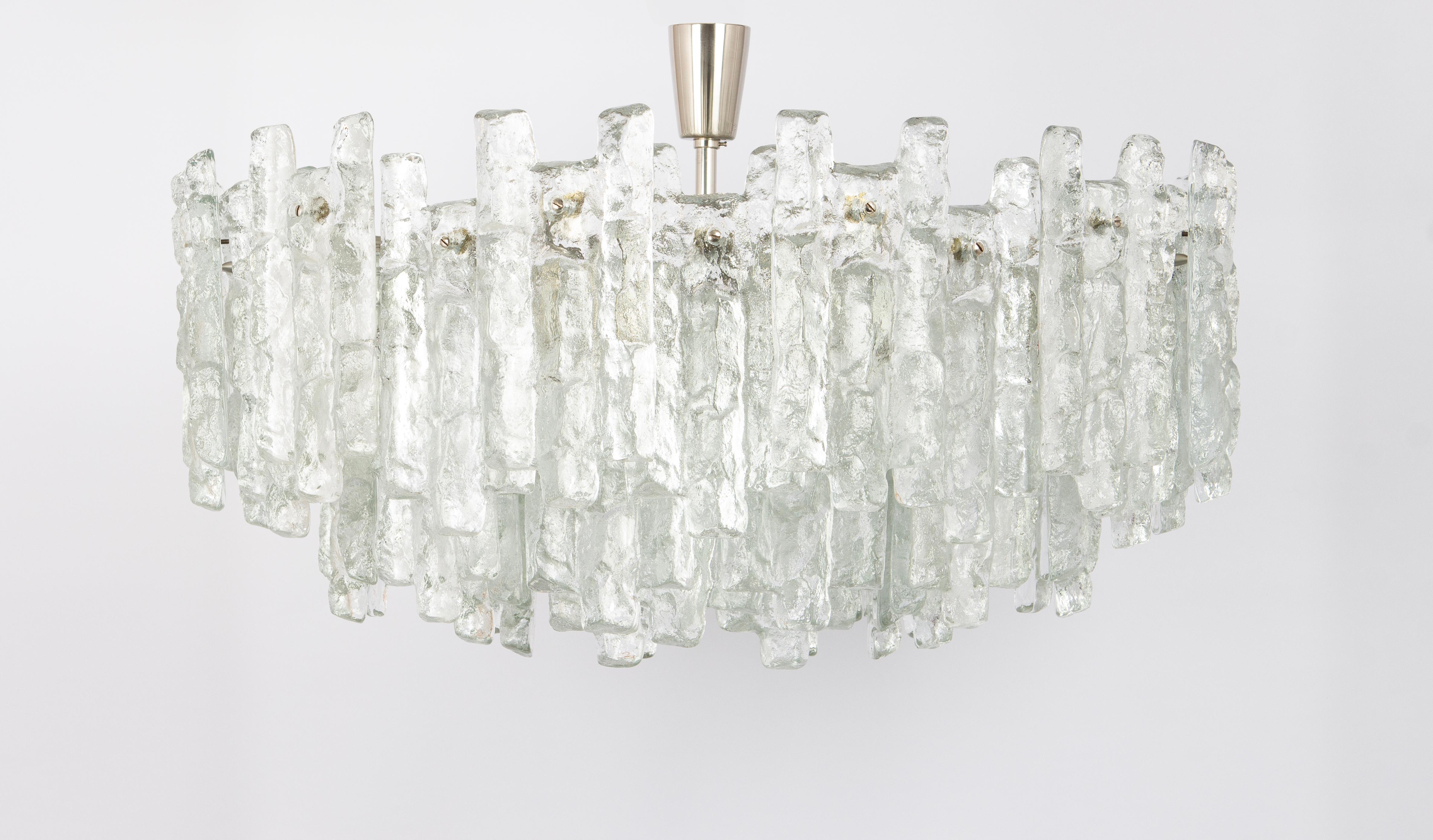 A Stunning large Chandelier with brilliant ice glasses made by Kalmar (Series: Soria), Germany, manufactured, circa 1970-1979.
Six tiers structure gathers many structured glasses, beautifully refracting the light, very high quality.

High quality