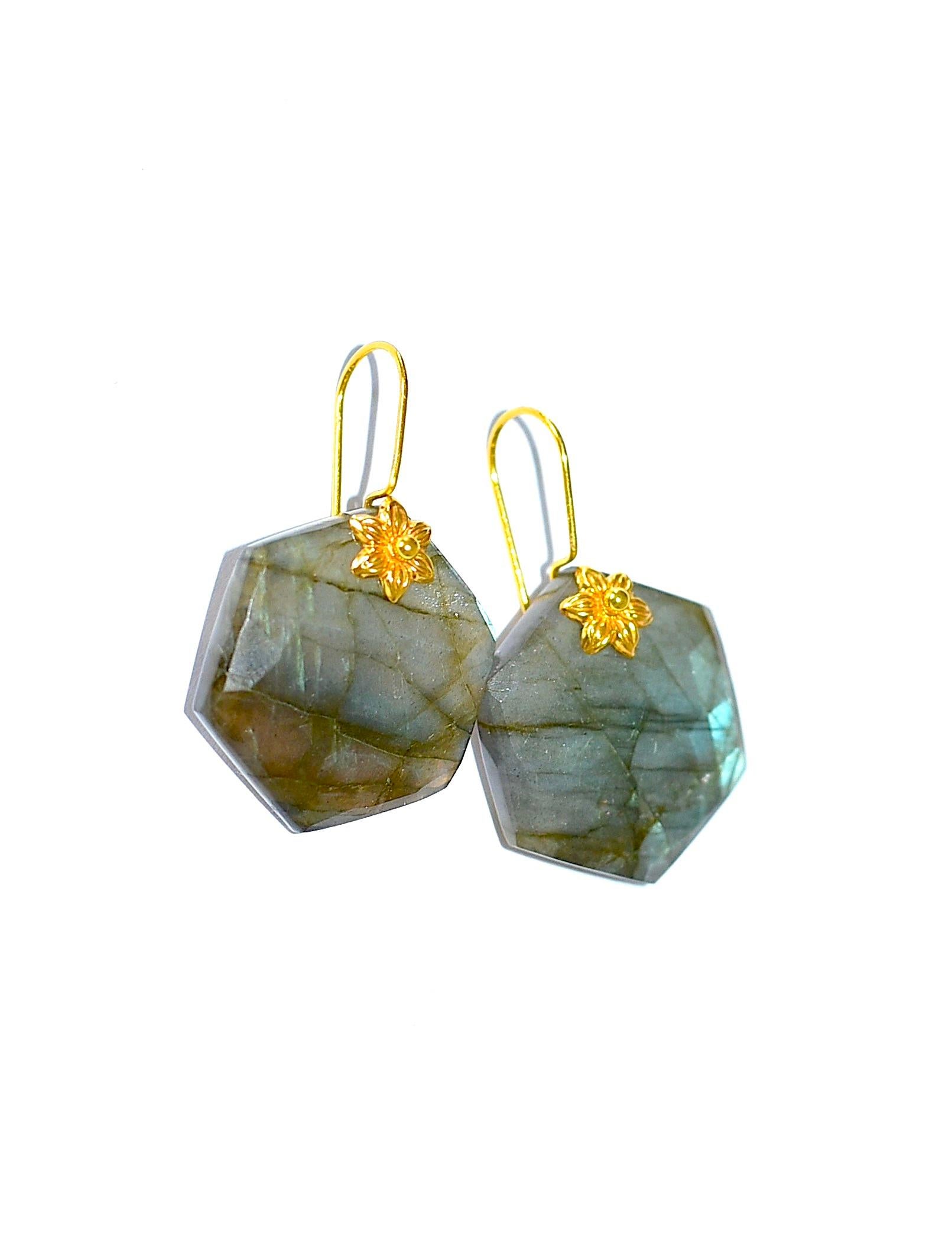 A game of gold and blue colors!! 
These big labradorite coins have wonderful blue and green flashes to them on both sides of each and have a nice organic look with large faceting. Measure 20mm wide, 22mm in length, and 6mm thick with faceting on