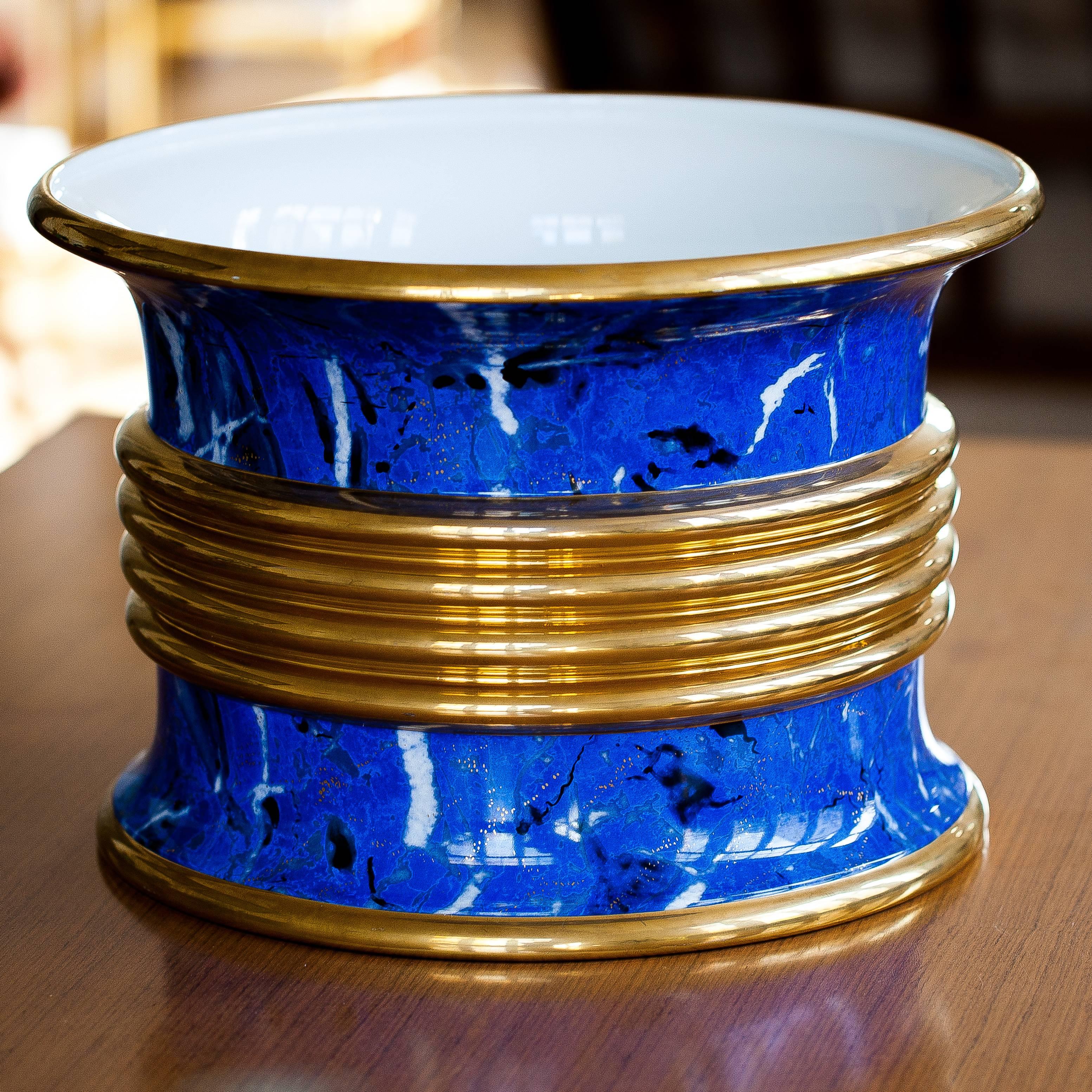 This cache-pot is so impressive. With a perfect lapis color and golden spotted this piece is very decorative. It was made in the 80s by Christian Dior, you can see the signature under the ceramic.