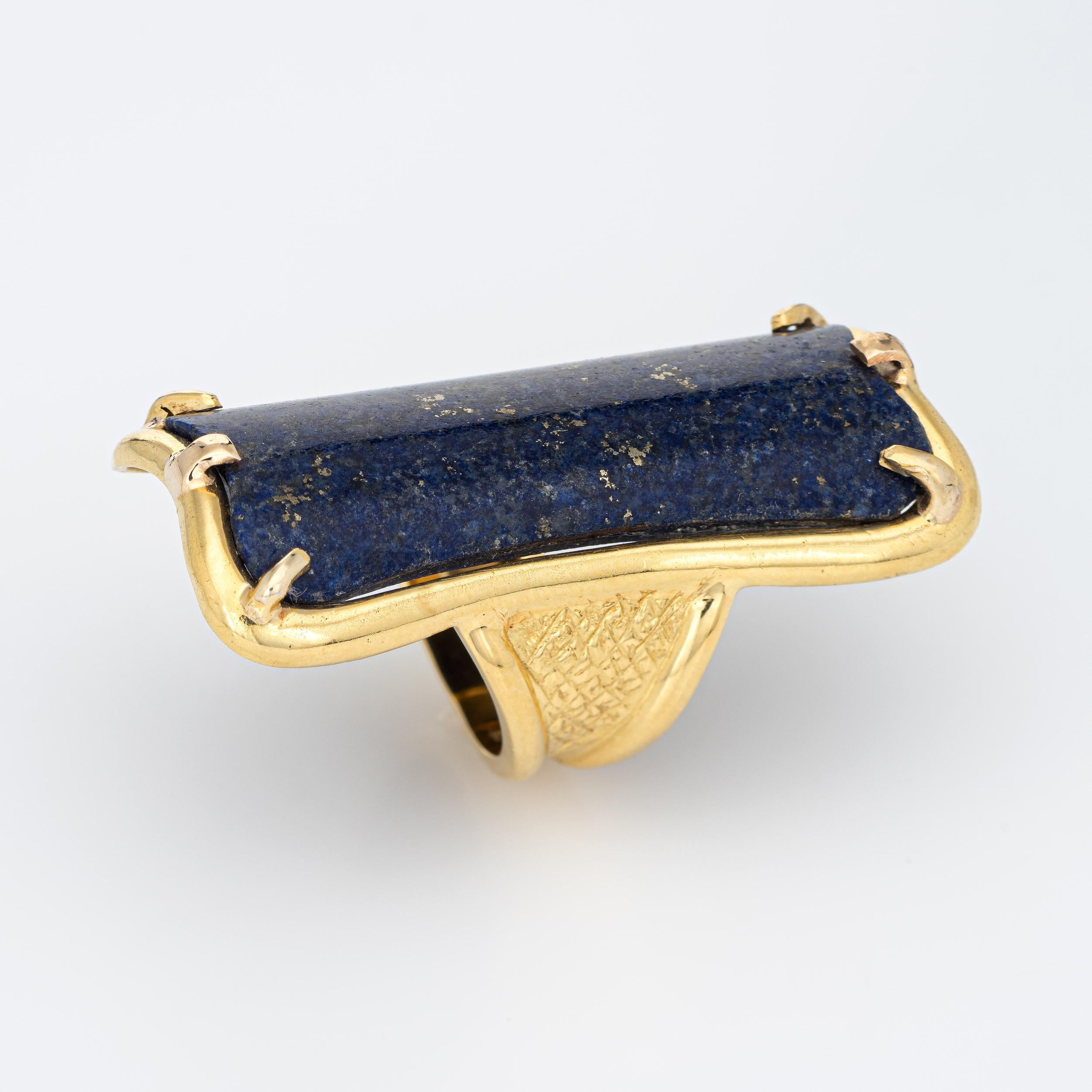 Stylish vintage lapis lazuli cocktail ring (circa 1960s to 1970s) crafted in 18 karat yellow gold. 

Lapis lazuli measures 37mm x 15mm (in excellent condition and free of cracks or chips). 

The exceptional vintage ring is one of the biggest and