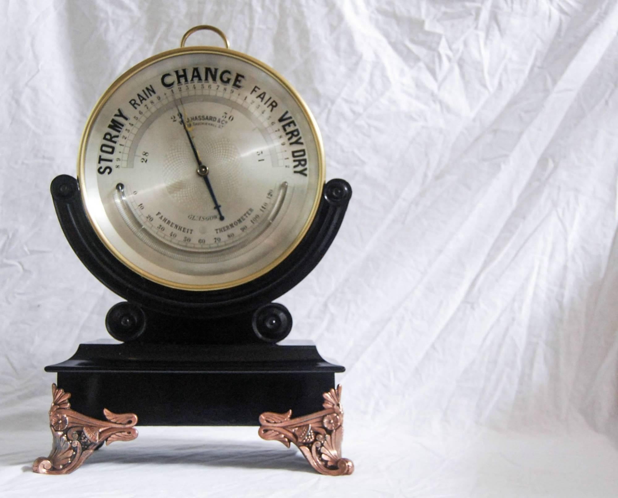 An extremely rare and unusual 10” dial brass aneroid barometer on ebonized stand and copper-plated decorative feet by WJ Hassard & Co, Opticians, 209 Sauchiehall Street Glasgow.

Apart from its unusual size this barometer also stands out for its