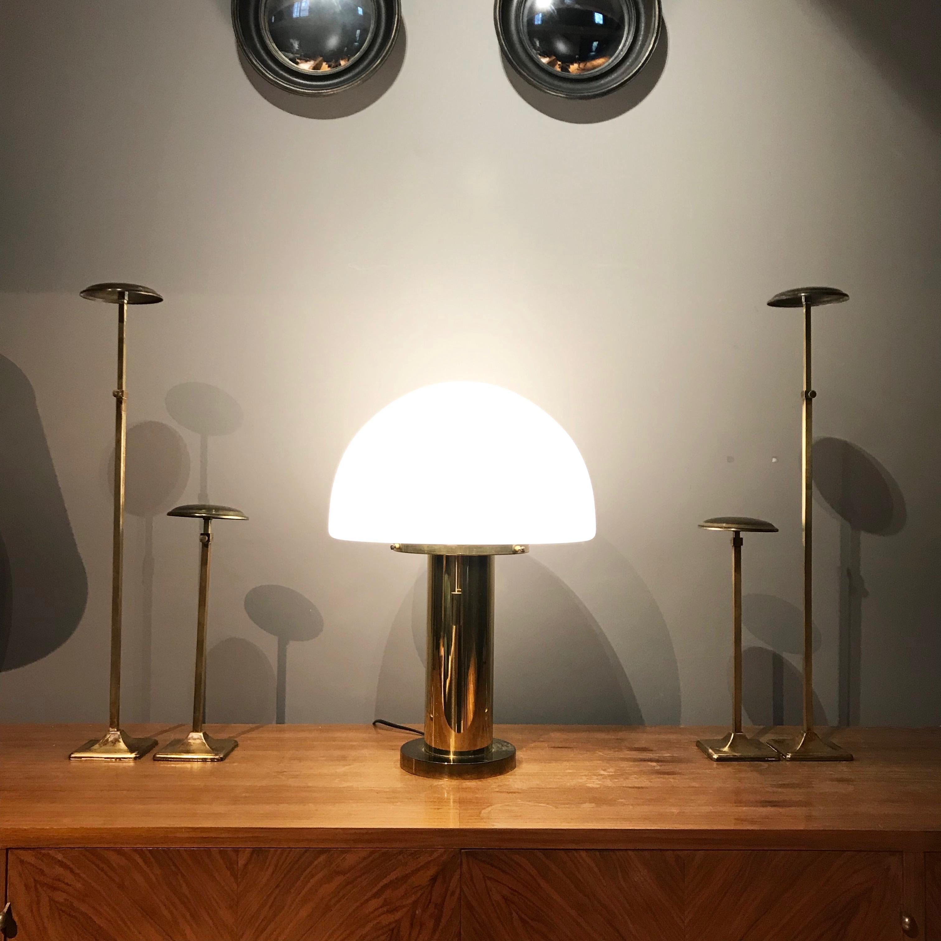 Simple and elegant space age sideboard lamp manufactured by Glashütte Limburg in Germany. The lamp is made of brass with heavy cast iron base. The mouth-blown lampshade that contains air bubbles provides smooth and wonderful light. The lamp is in