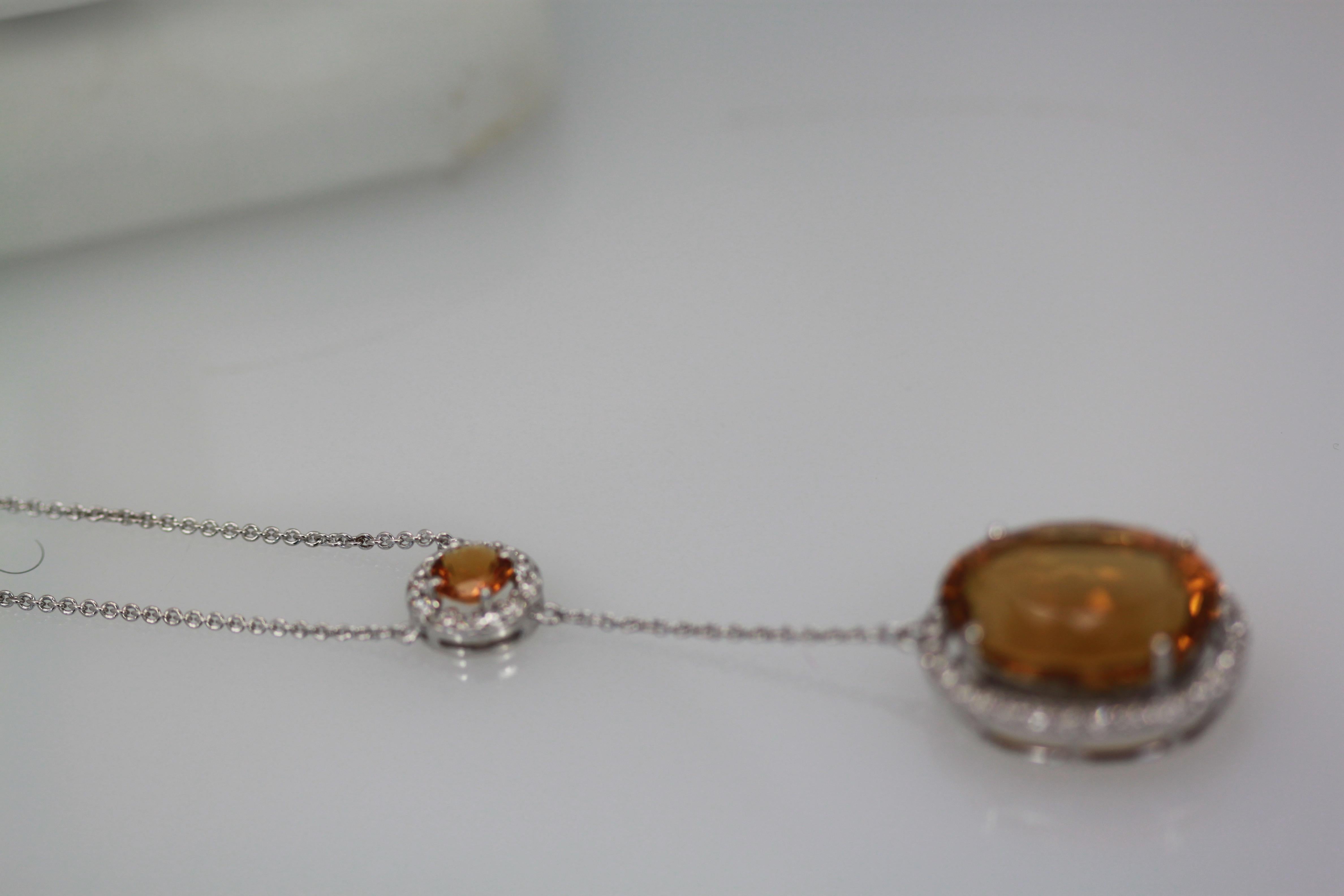 This gorgeous mixed cut Maderia Citrine is huge and beautiful.  This necklace is a drop style with a 1.50 carat round Citrine and a large oval Citrine drop with a Diamond surround. This large Citrine comes from Brazil and is gorgeous it measures