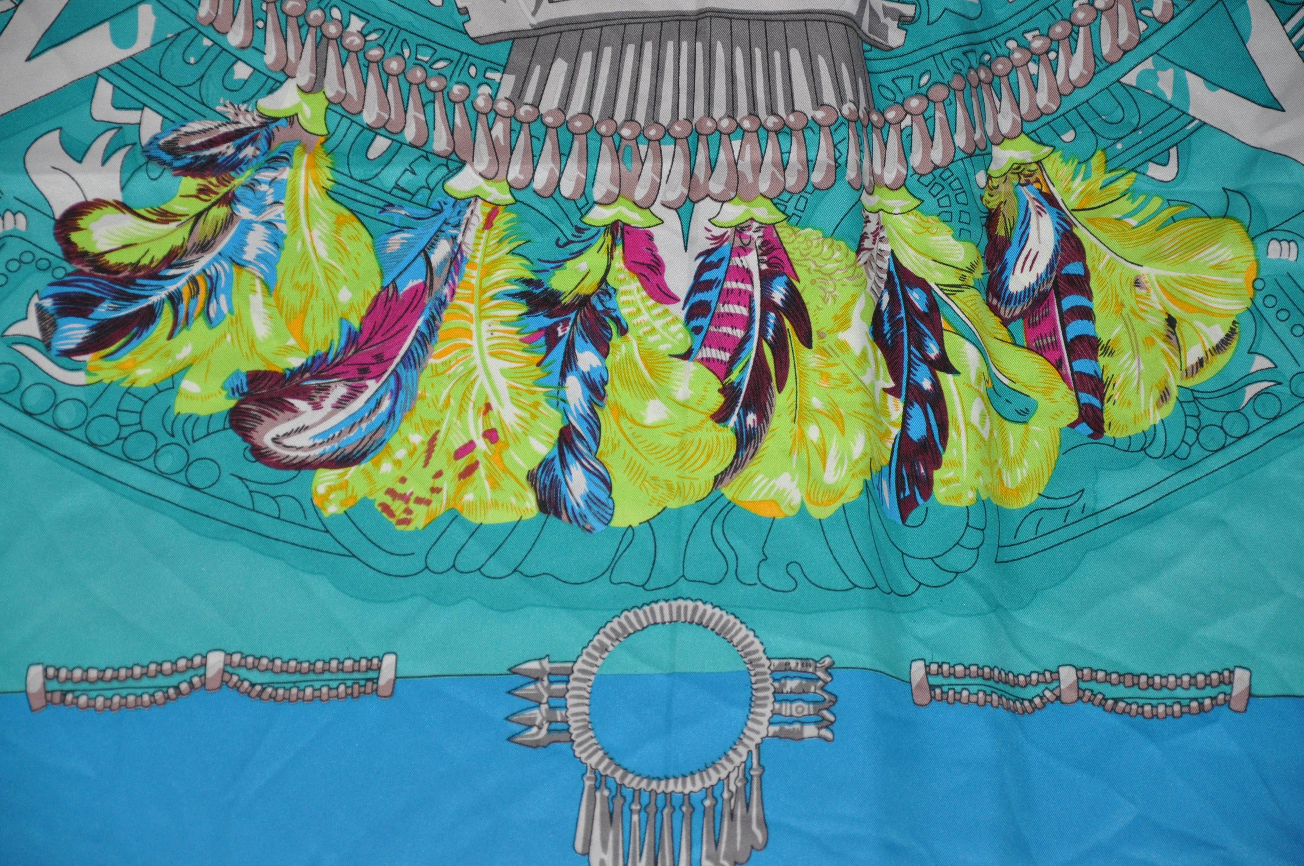     This magnificently beautiful Turquoise accented with vivid multi color headdress accented with hand rolled edges, measures 50 inches by 50 inches. Made in France.