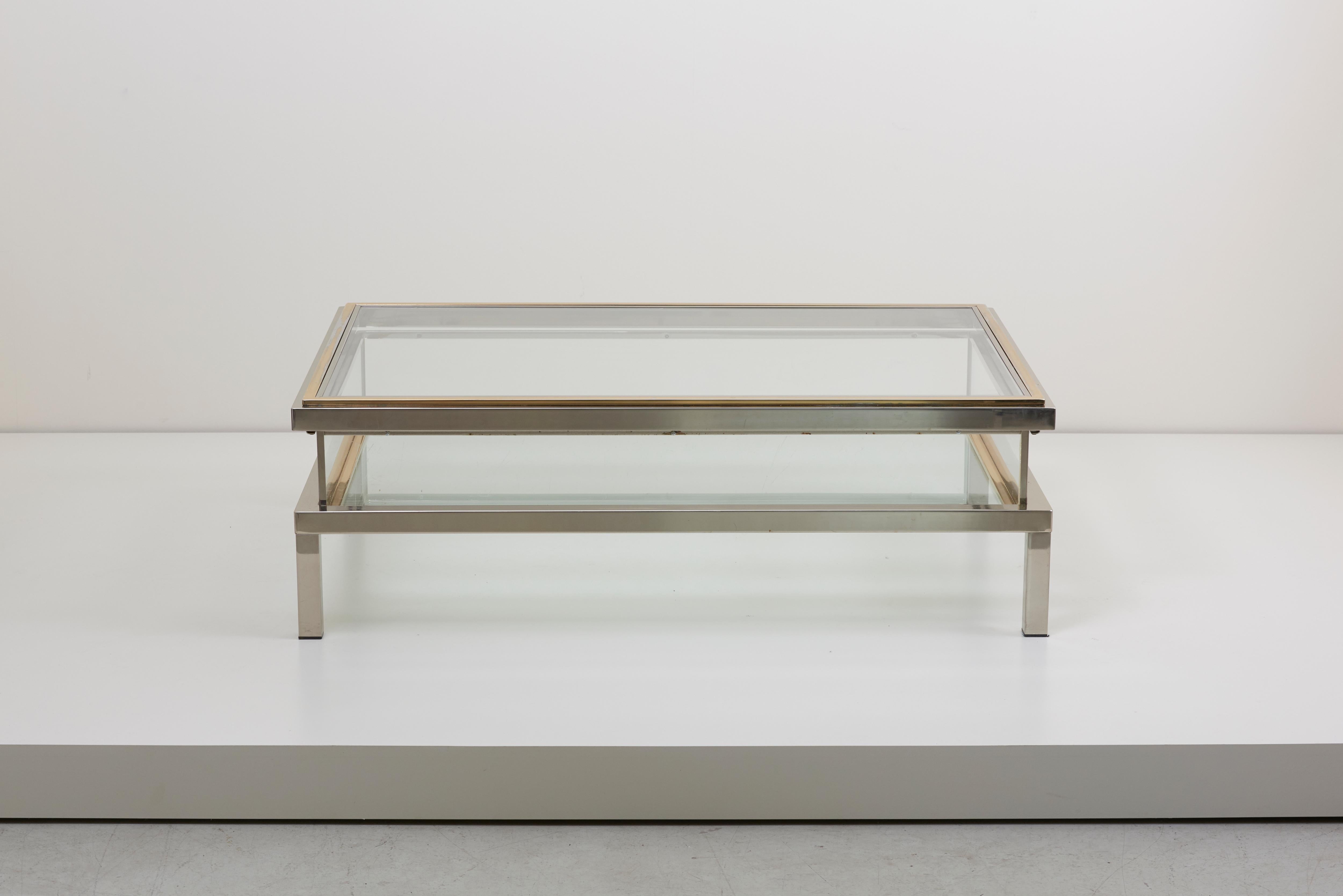 Elongated glass table with sliding top by Maison Jansen. Frame has an total original gold-plated and chrome metal finish.