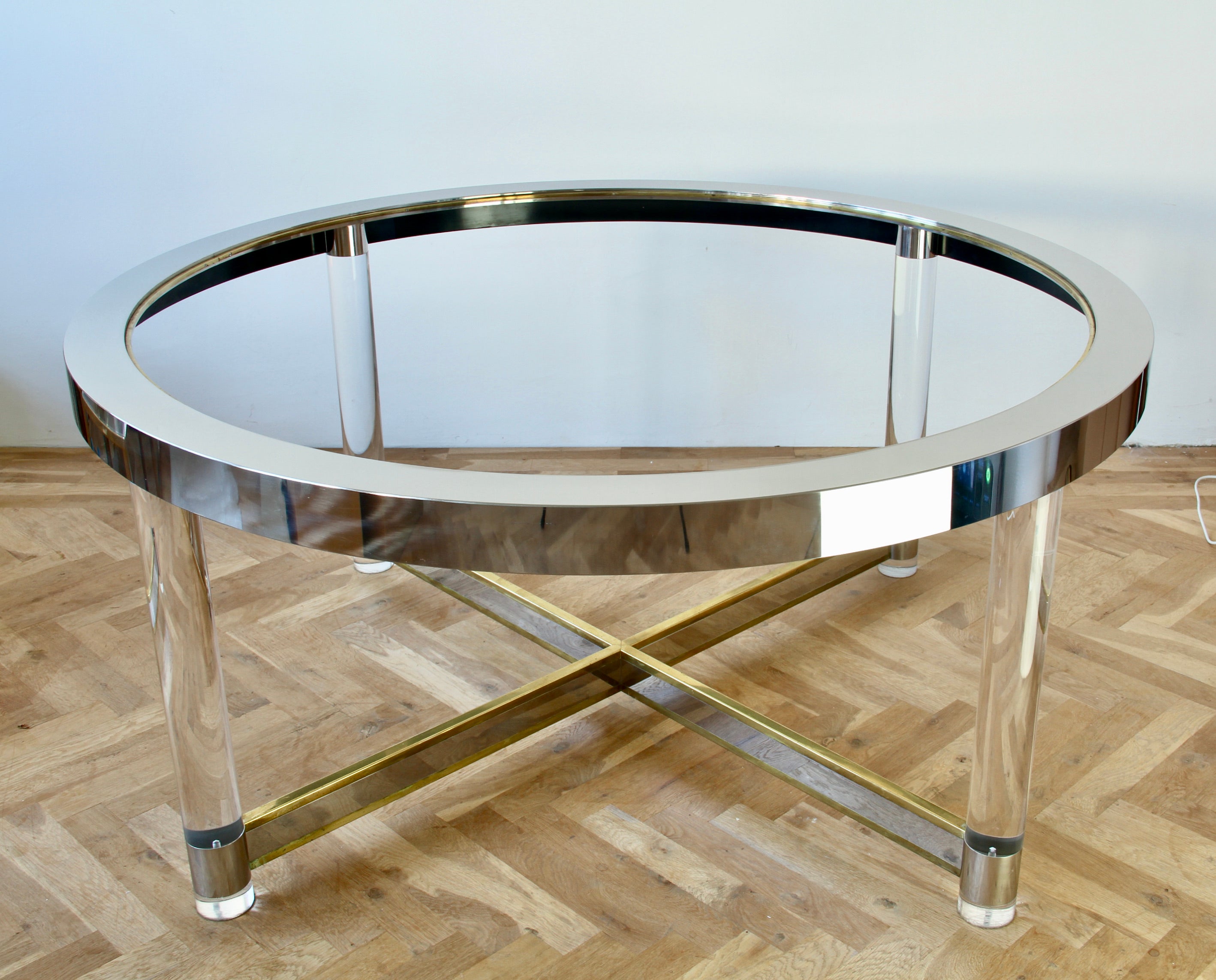 Stunning large vintage Mid-Century modern dining table in polished brass and chrome with acrylic / Lucite legs in the style of Maison Jansen, Karl Springer and Charles Hollis Jones circa 1970s. Perfect for the Hollywood Regency style enthusiast or