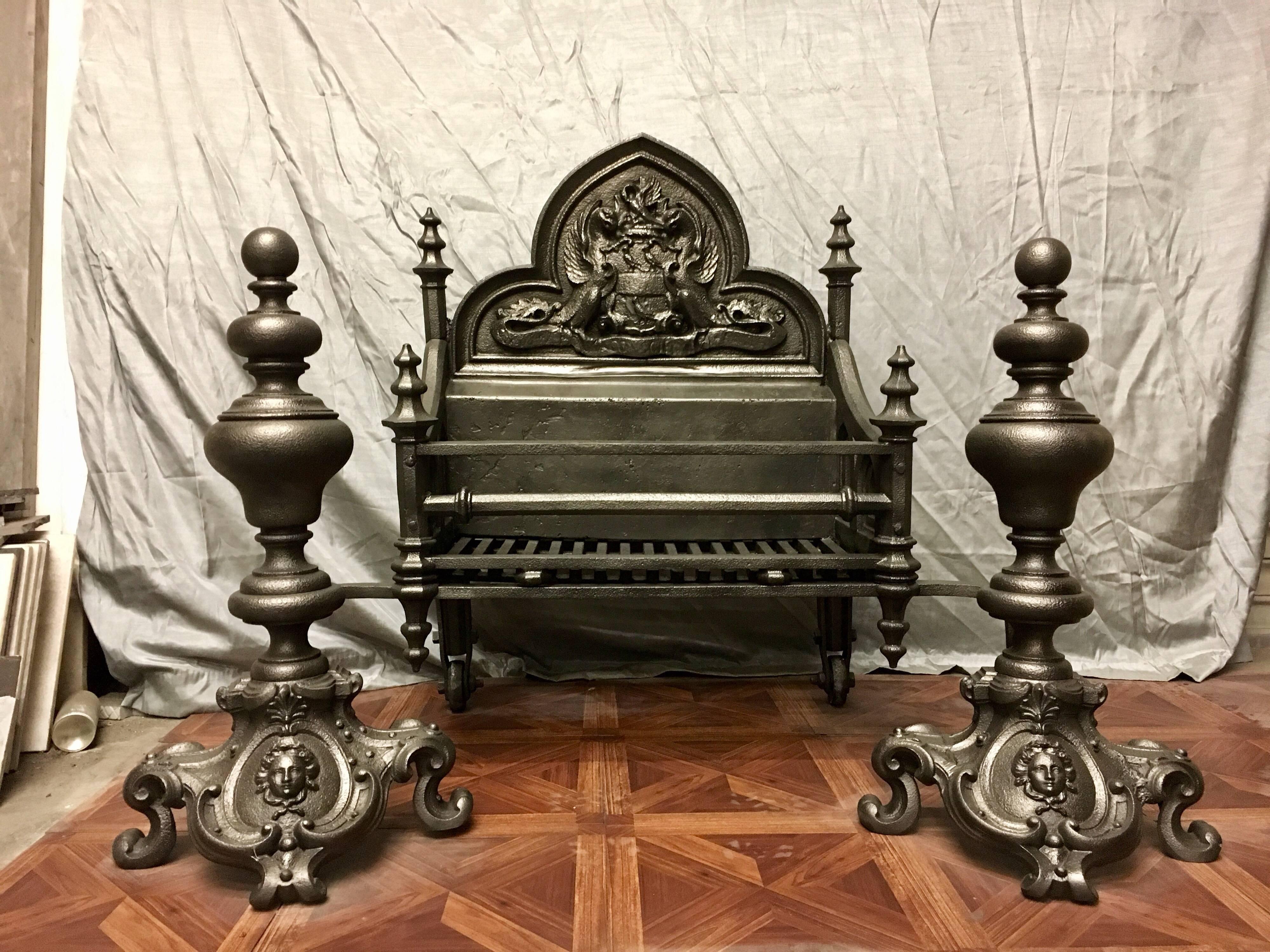 A very large and Majestic ornately detailed antique 19th century Victorian cast iron fire grate in the Gothic-Revival manner. The large Doric arched backplate centred with an Heraldic Plaque displaying a Phoenix crest on the mantel and a halted