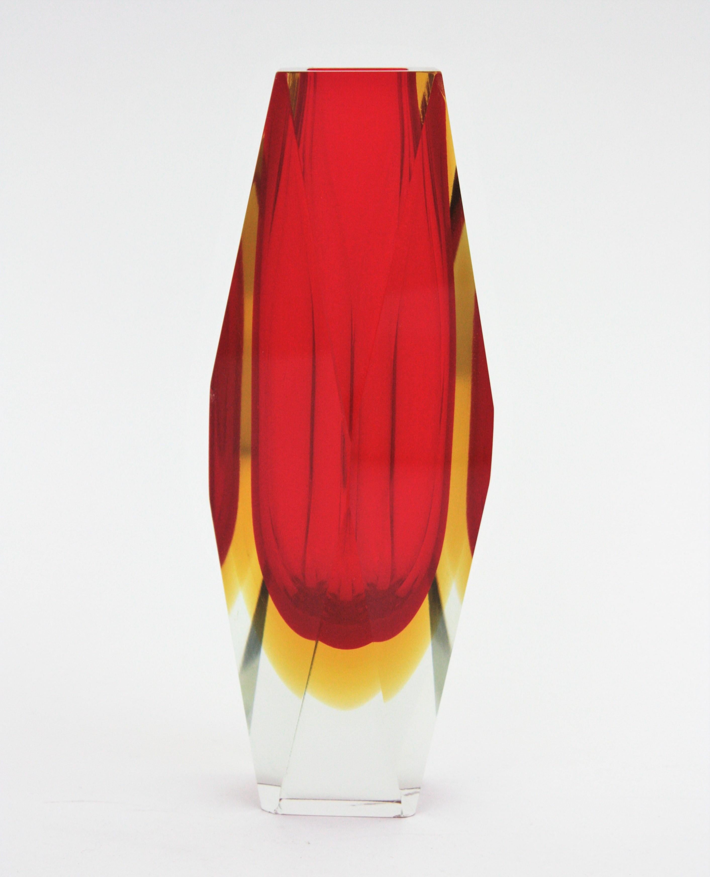 A beautiful 25 cm height faceted Sommerso double cased red and yellow Murano glass vase. Attributed to Mandruzzato, Italy, 1960s
Red glass with a layer of yellow glass cased into clear glass. The vibrant red color is eye-catching.
Beautiful to be