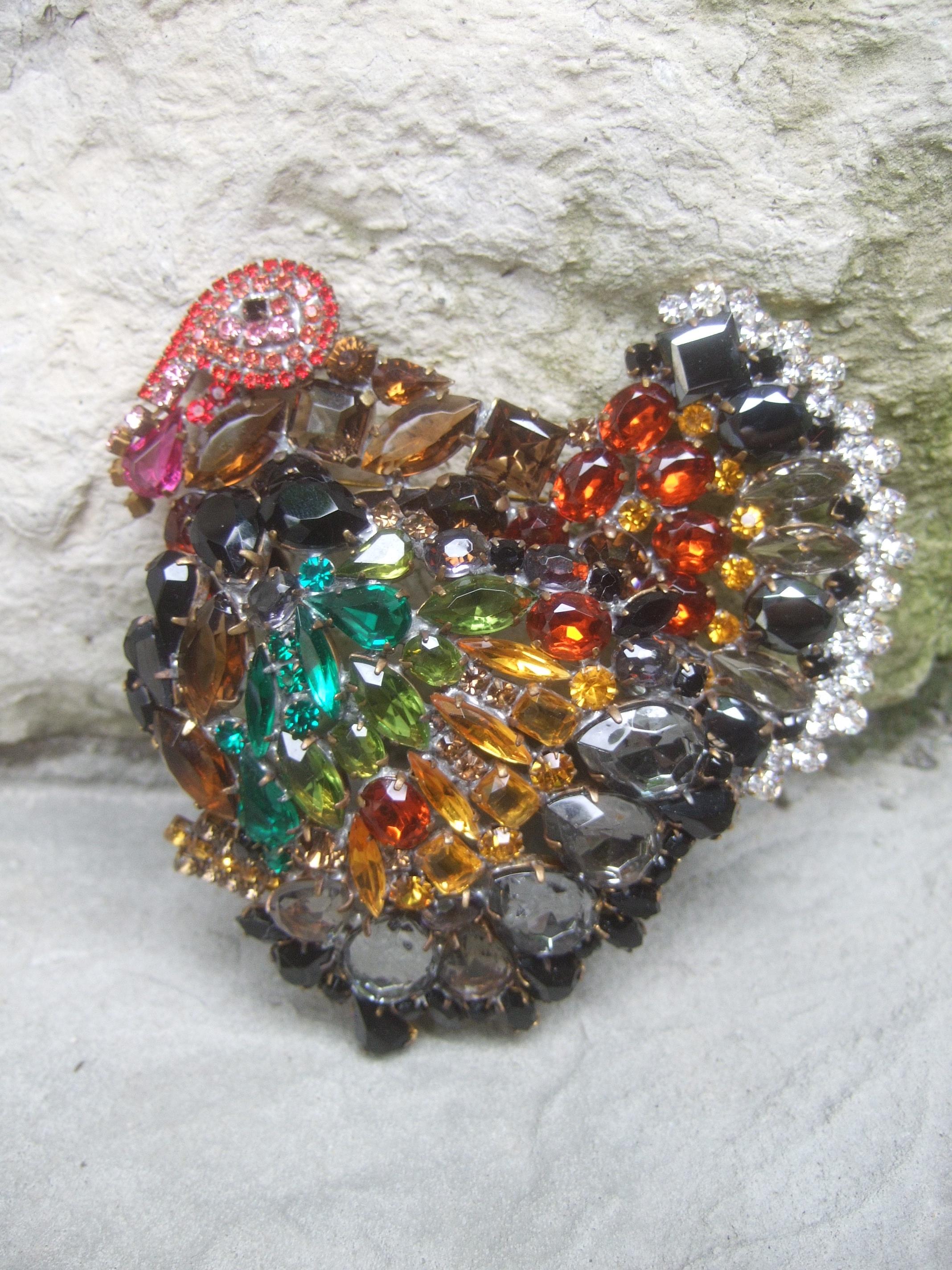 Huge massive glittering crystal turkey brooch designed by Lilien c 1980s
The large-scale showstopping figural turkey brooch in encrusted with a collection of glittering prong set crystals in autumn earth tone colors;
ranging from golden amber, deep