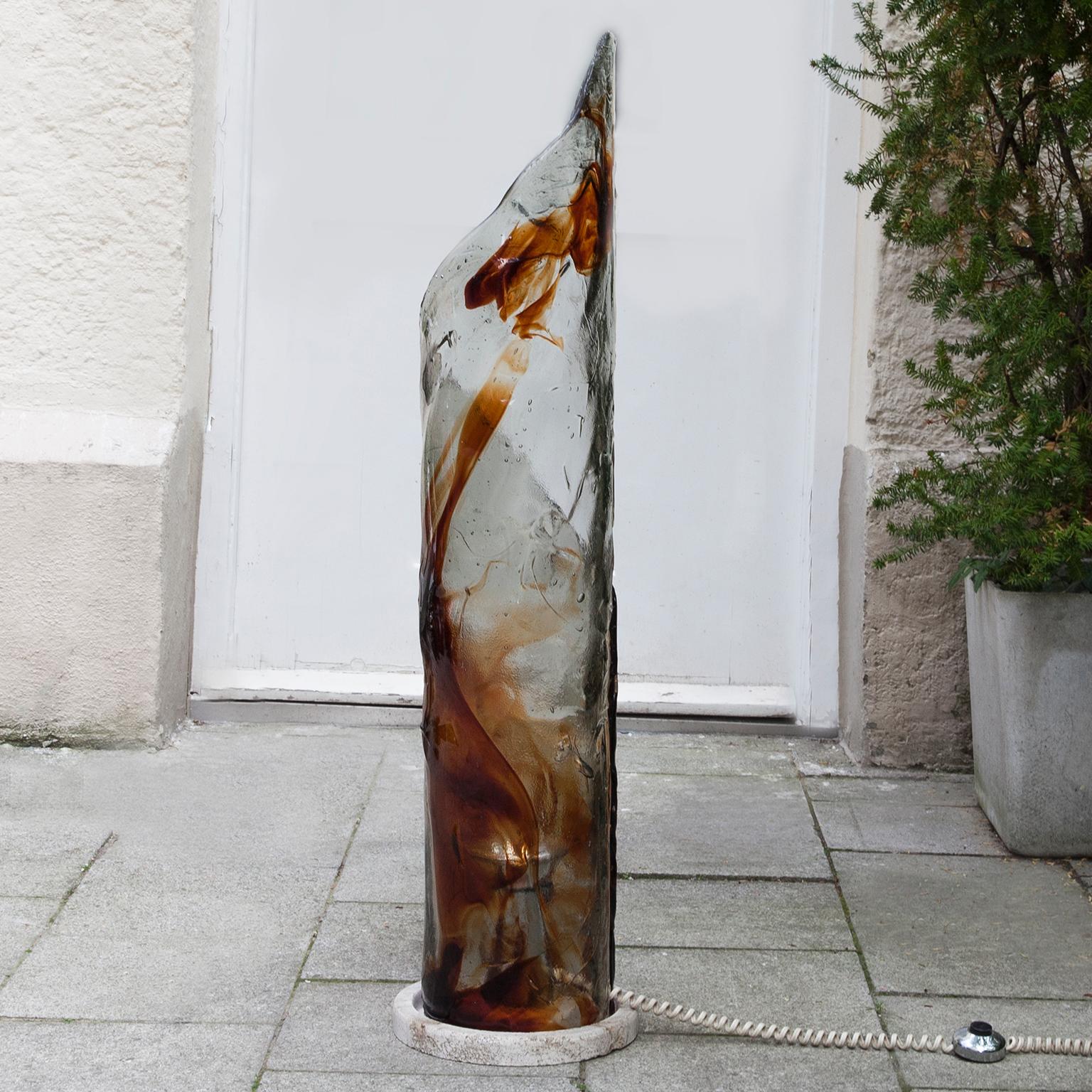 Murano glass floor lamp sculpture attributed to Carlo Nason for AV Mazzega, Italy, 1970s. Beautiful travertine base with heavy amber and clear colored Murano glass. Carlo Nason is probably one of the most important Murano glass makers. 1 sockets