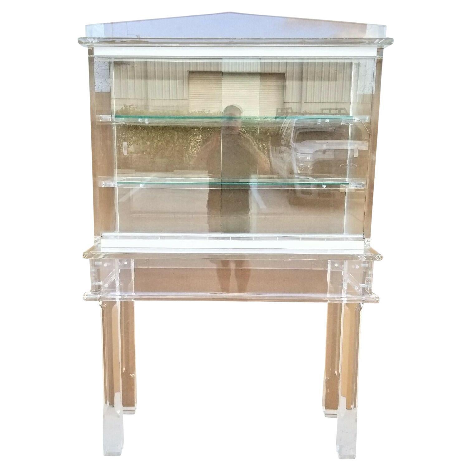 Offering One Of Our Recent Palm Beach Estate Fine Furniture Acquisitions Of A Custom Made 1970's Exceptional Huge MCM Neo-Classical Hollywood Regency Style Lucite 2 Piece Dry Bar Display Cabinet 
Featuring 2 thick glass shelves and 2 sliding front