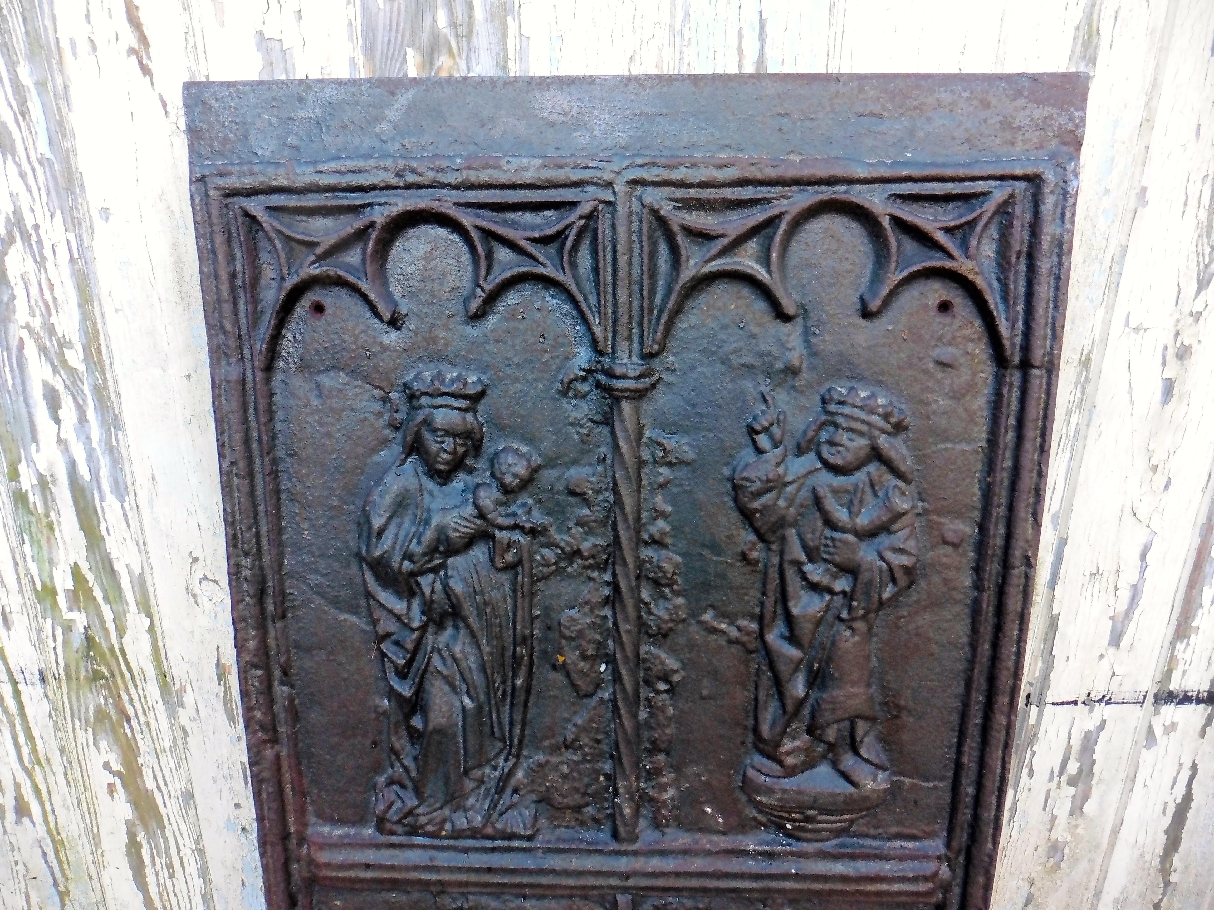 Huge medieval French iron ecclesiastical panel a wonderful inglenook fire back

This is a very old piece, as far as I can find out it was found behind a 19th century fireplace. The panel shows various medieval looking religious figures, in each