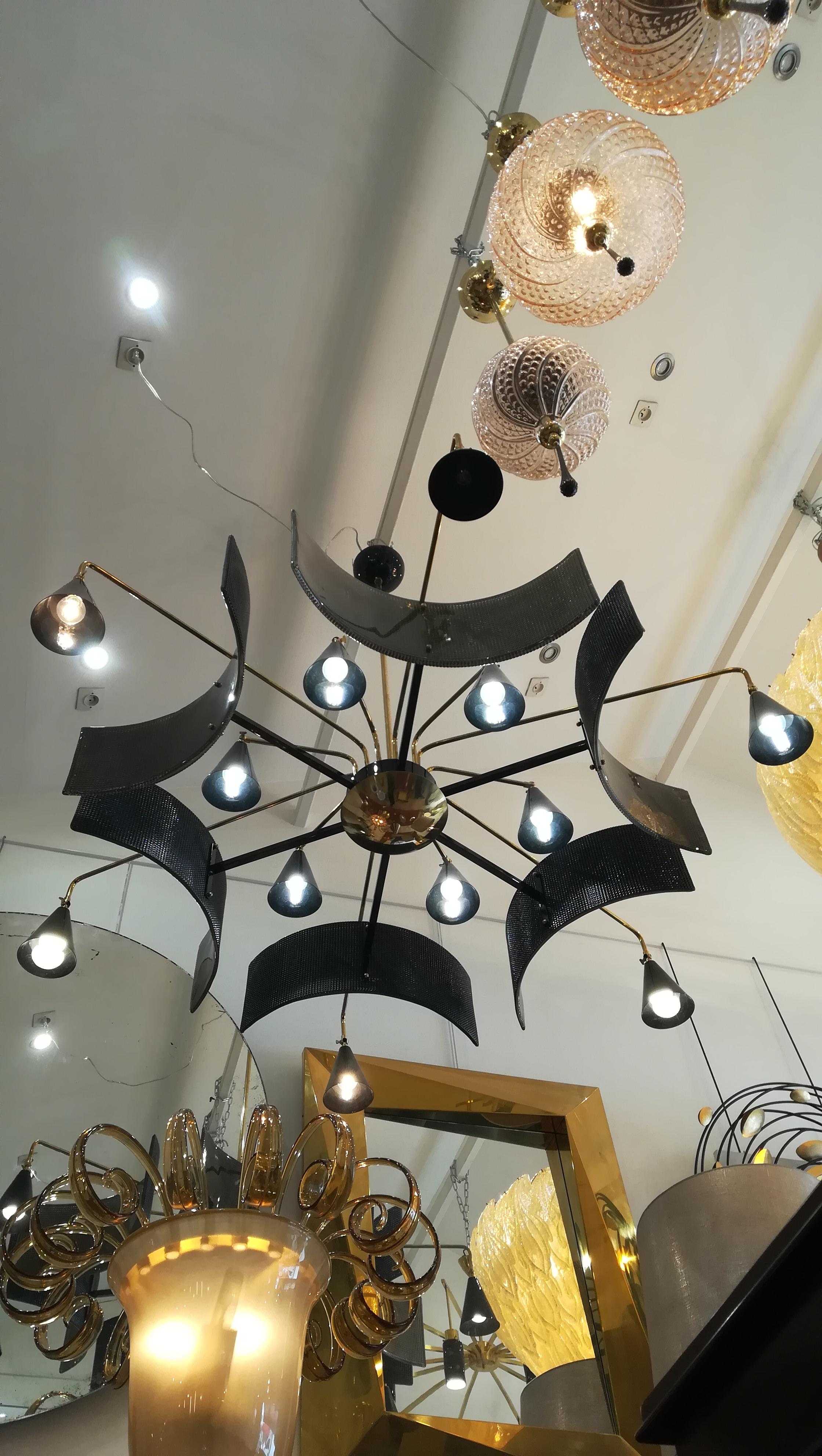 Huge metal and glass chandelier, 12 bulbs E14 in adjustable metal lampshades and murano glass decorative reflectors. Brass arms.