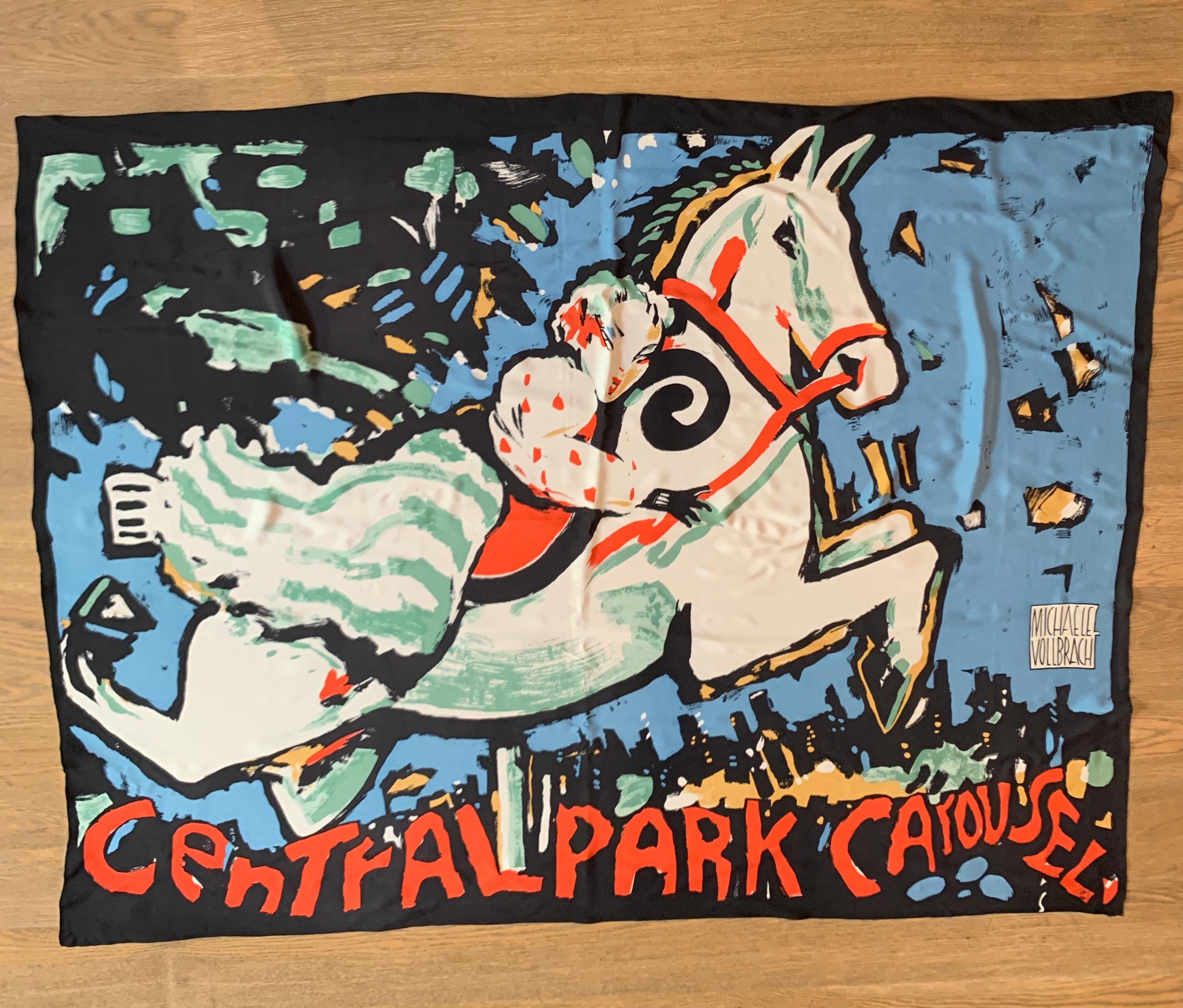 Stunning and super large Michaele Vollbracht silk scarf featuring a rider on the Central Park Carousel. Glue, green, tan, and red on white and black print showcases Vollbracht's painterly style. Reads 