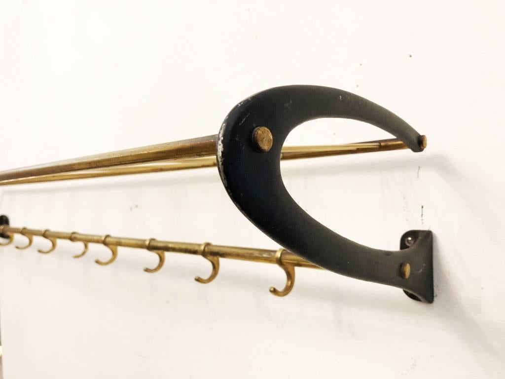 Brass construction with blackened aluminum brackets in the style of Carl Auböck. Made in Austria in the 1950s.