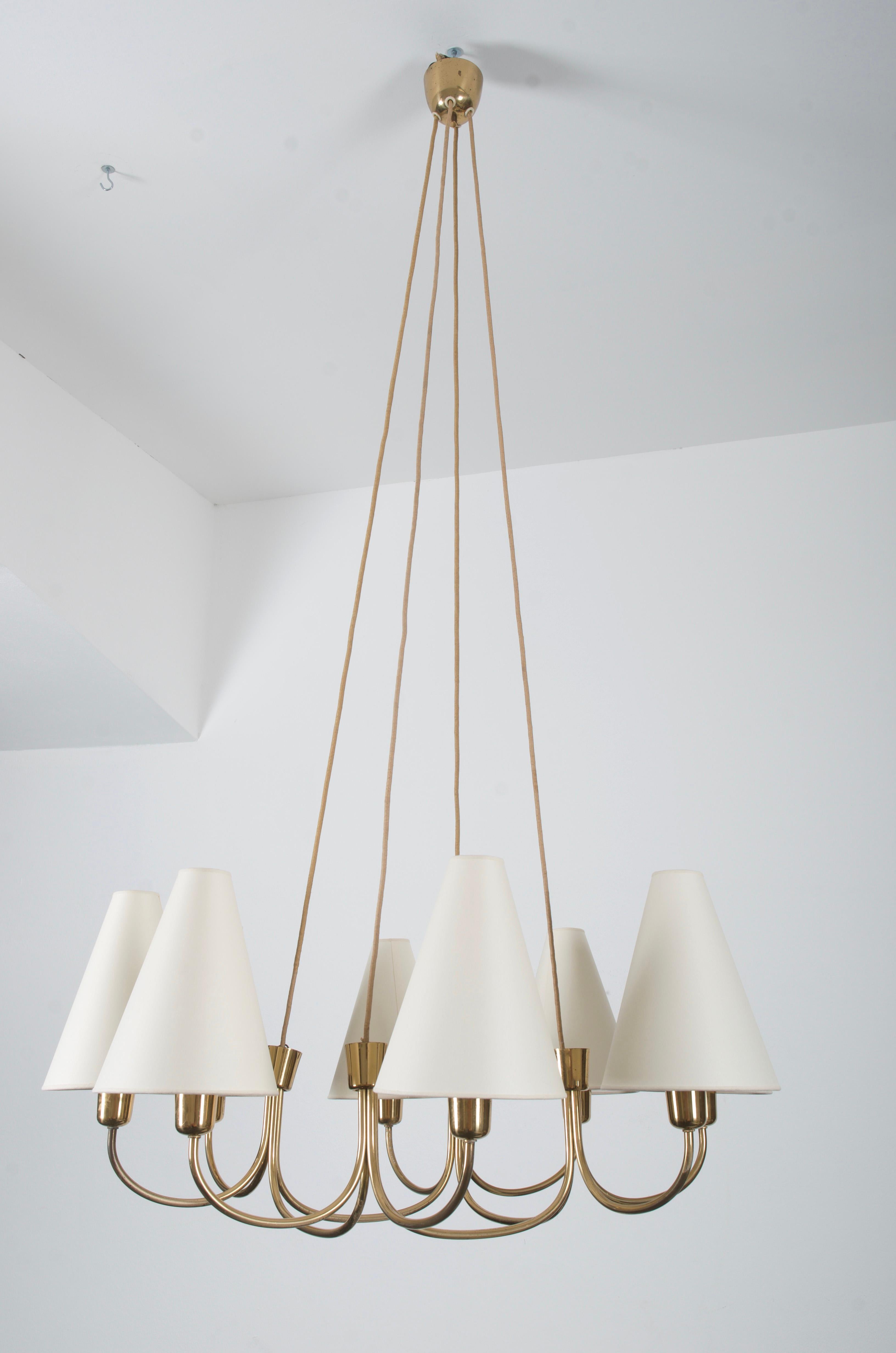 Brass construction with eight arms and cone shaped shades each fitted with E27 socket. Made in Vienna by Rupert Nikoll in the early 1955.
  