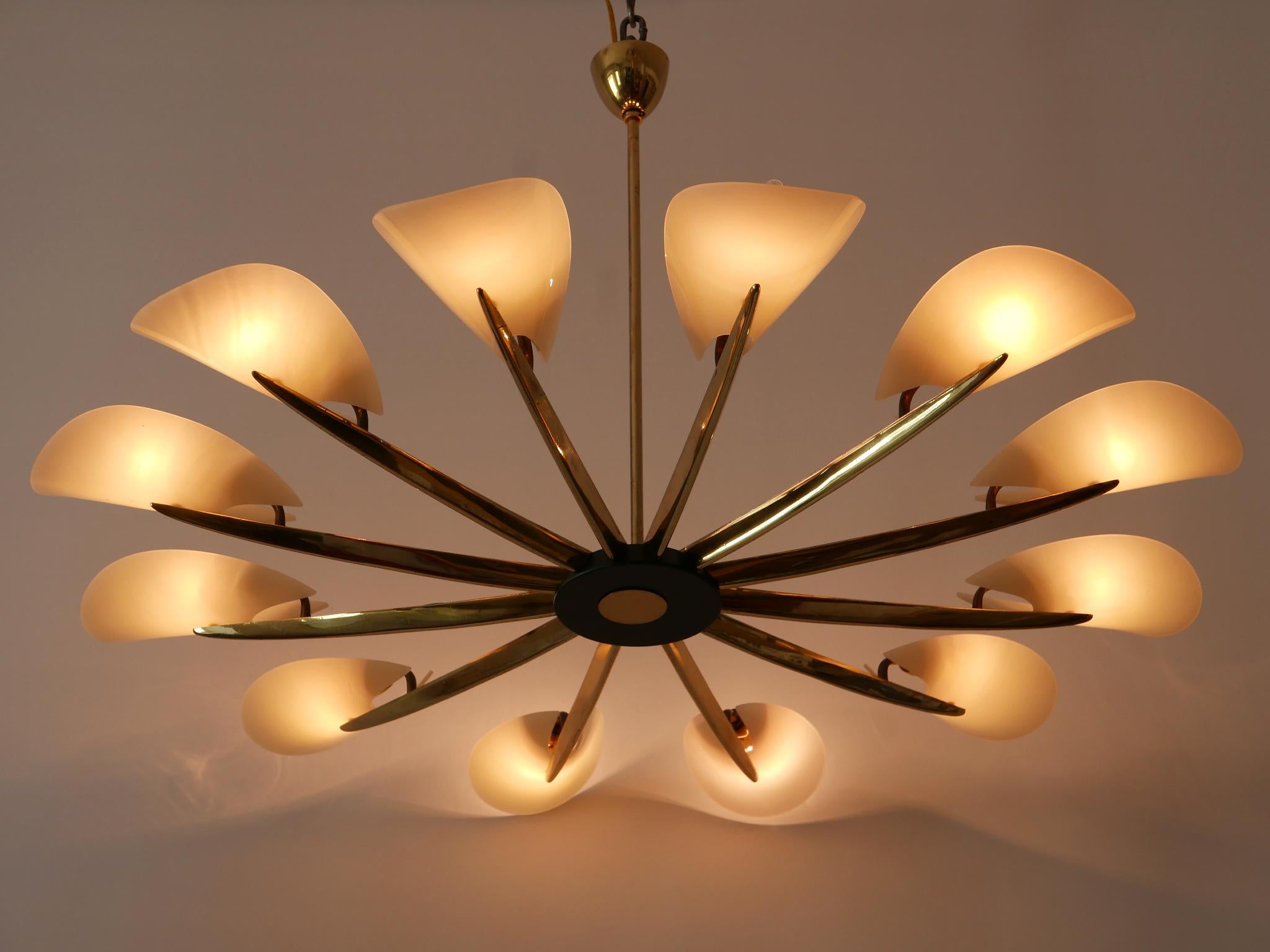 Exceptional, large 12-armed Mid-Century Modern Sputnik chandelier or pendant lamp. Designed and manufactured in Germany, 1950s.

Executed in brass and Lucite, the chandelier / pendant lamp needs 12 x E14 / E12 screw fit bulbs. It works both with 110