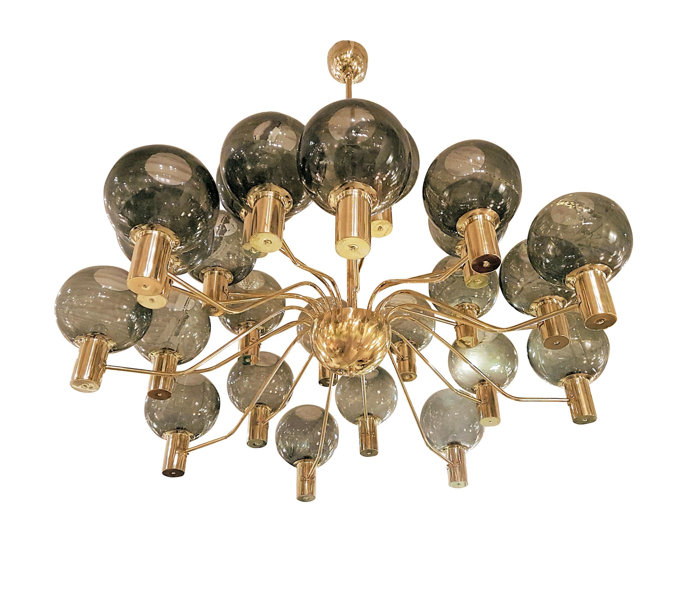 Extra large Mid-Century Modern 24-light polished brass chandelier, attributed to Hans Agne Jakobsson, Sweden, 1970s.
This large chandelier has 24 beige and transparent glass globes, covering the light bulb. 
It has been rewired with UL materials,