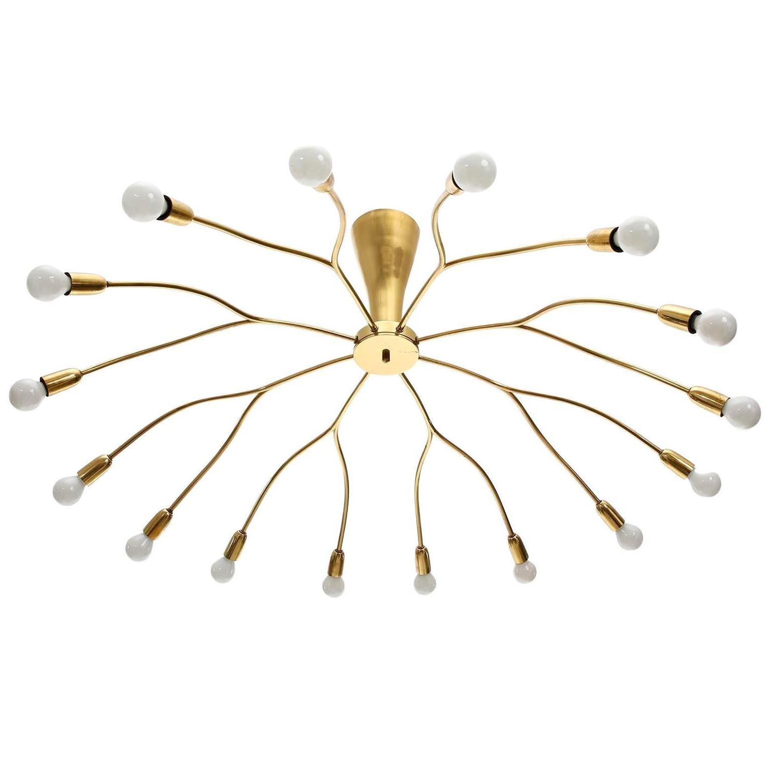 An impressive and extra large 16-arm Mid-Century Modern brass spider flush mount fixture or chandelier by Kalmar, manufactured circa 1960 (late 1950s or early 1960s).
The lamp has 16 sockets for small Edison screw base bulbs type E14 with max. 40 W