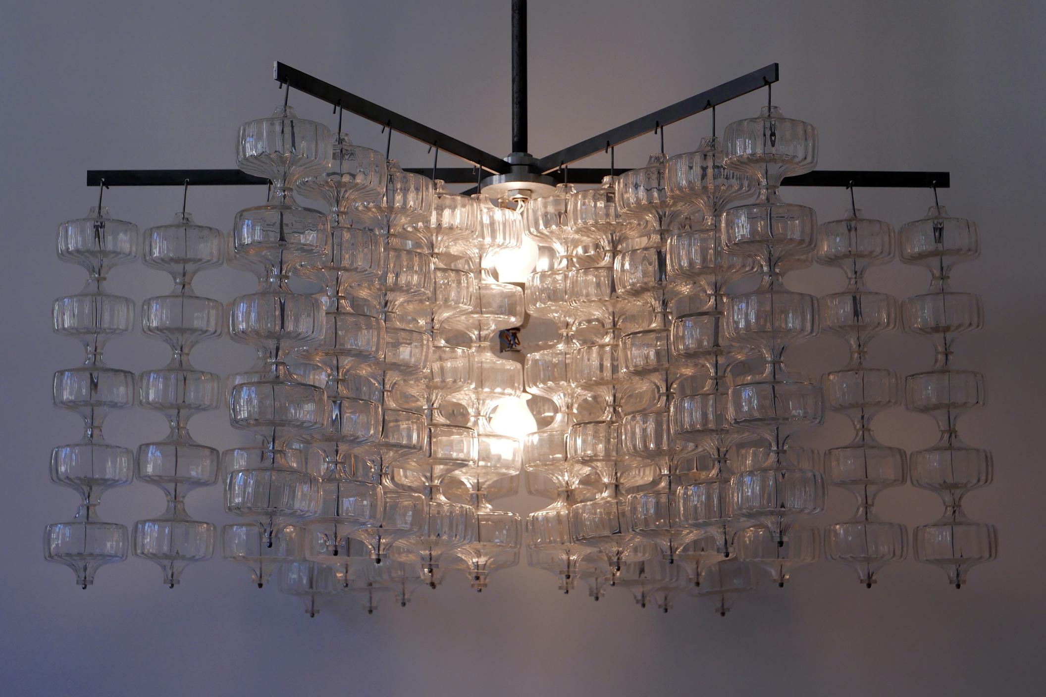 Huge, spectacular Mid-Century Modern chandelier or pendant lamp by Aloys Ferdinand Gangkofner, 1968, Germany.

Executed in hand blown glass, this exceptional chandelier comes with 150 glass elements which hang from 6 steel arms in five rows.
It