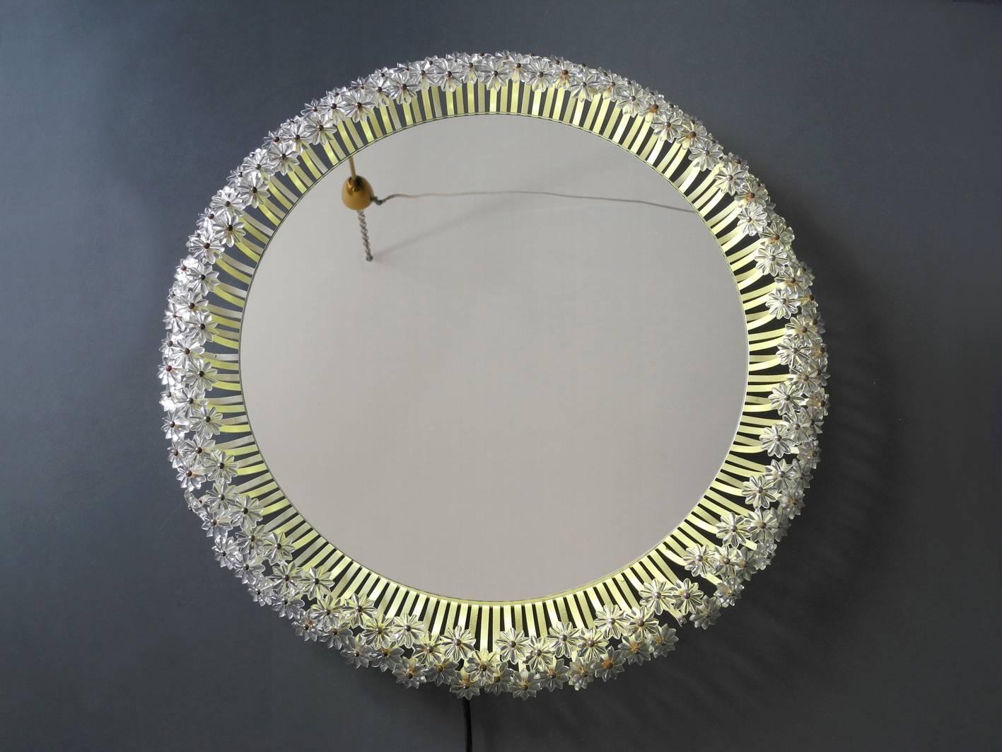 Marvelous round backlit large Mid-Century Modern flower mirror by Rupert Nikoll. Great elaborate design with many small plastic flowers. Back made of wood. Illuminated with a neon ring with 220V transformer. For countries with a 110V connection,