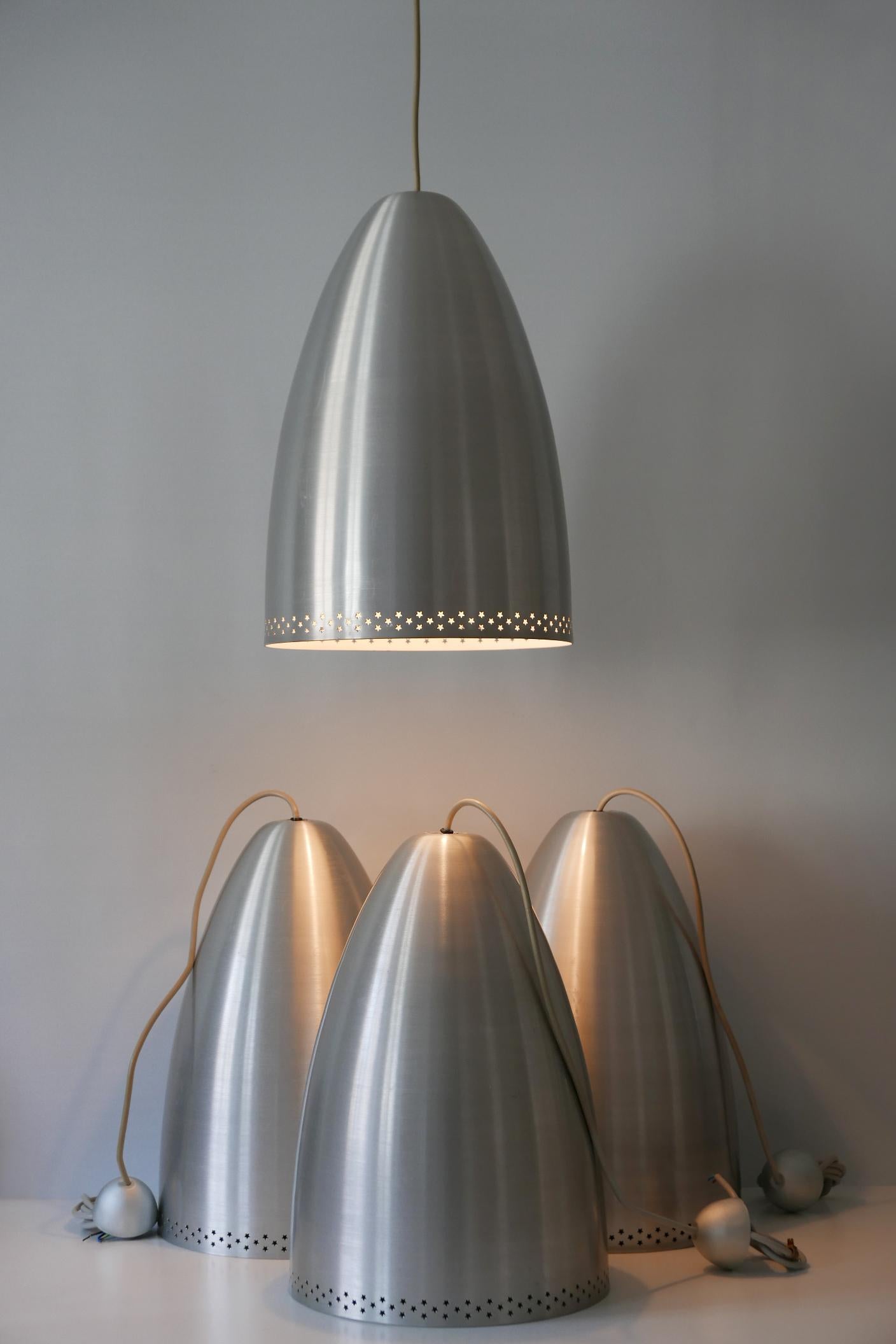 Elegant Mid-Century Modern pendant lamps or hanging lights. Manufactured in Germany circa 1970s.

Executed in perforated solid aluminum, each lamp comes with 1 x E27 Edison screw fit bulb holder, is wired, and in working condition. It runs both on