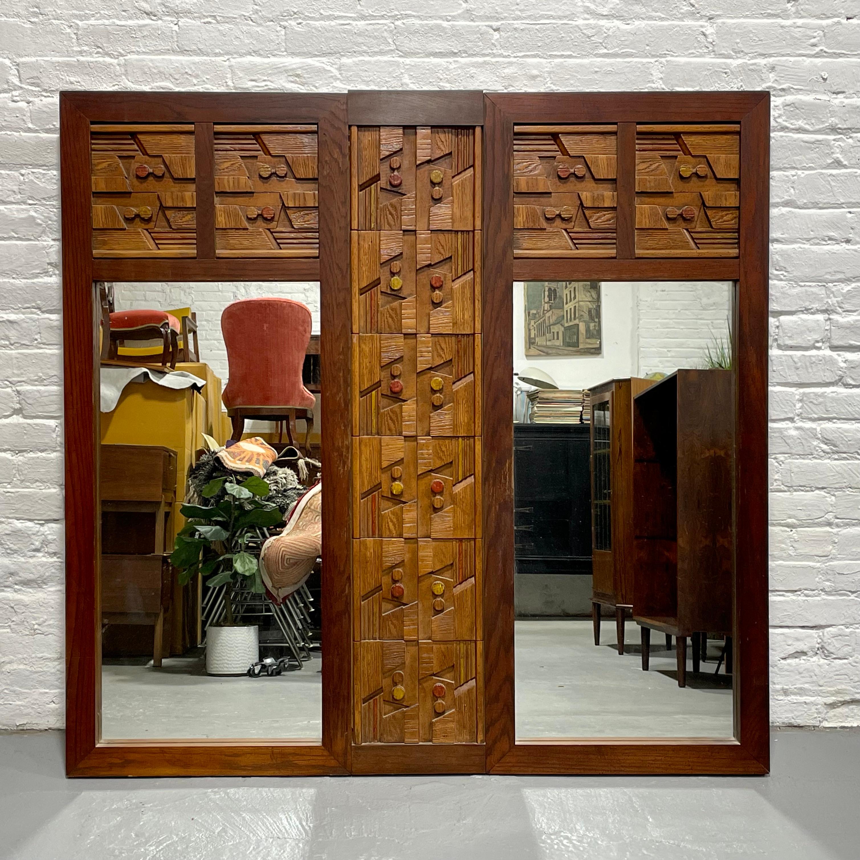 Huge Mid Century Modern Walnut Brutalist styled Mirror in the style of Paul Evans, circa 1960's. The façade consists of a highly textured pattern of rough hewn shapes and each piece was carefully sculpted from solid wood with brutalist, pueblo