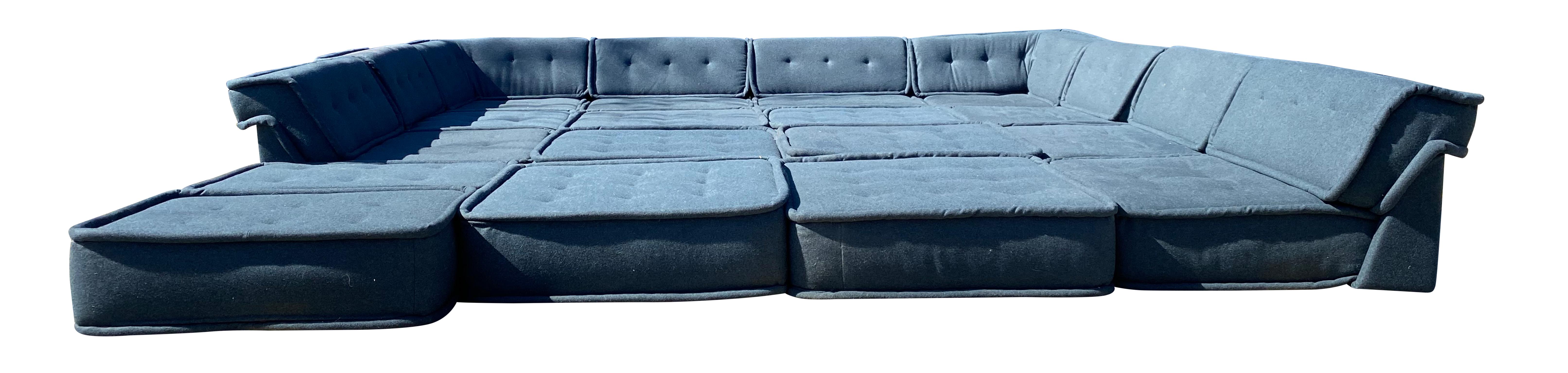 Massive (24) sections of a modular modern low sectional floor sofa. Very fun and interchangeable. (24) sections total upholstery is in good vintage condition. All blue or gray wool. Foam is very nice and firm but very comfortable. Create your own