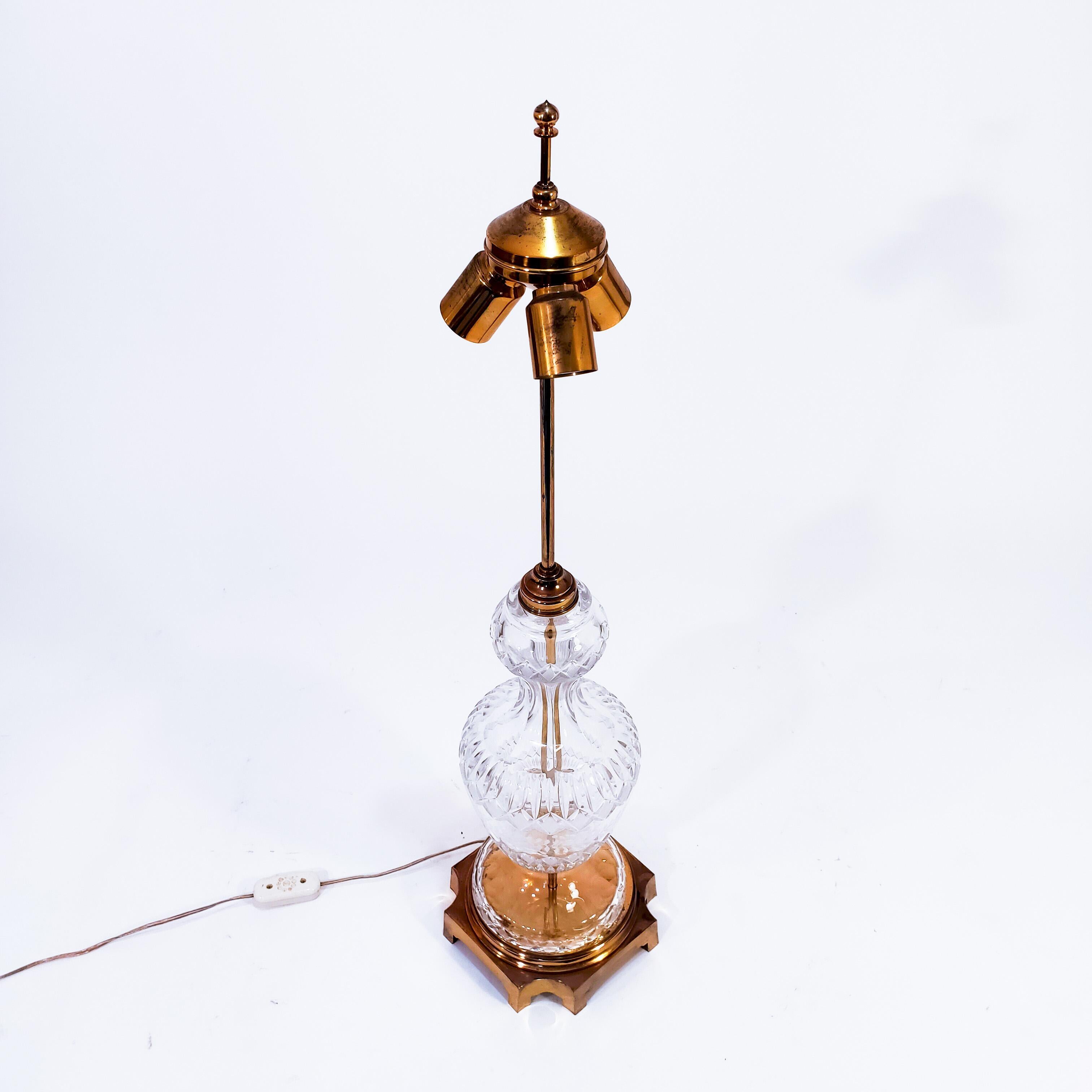 Huge table lamp from Waterford Crystal, Ireland, 1960s. The glass body is 39 centimeters high made of one-piece molded glass with engraved and cutted details. The base and the structure is made of solid bronze and brass. A very rare piece of great