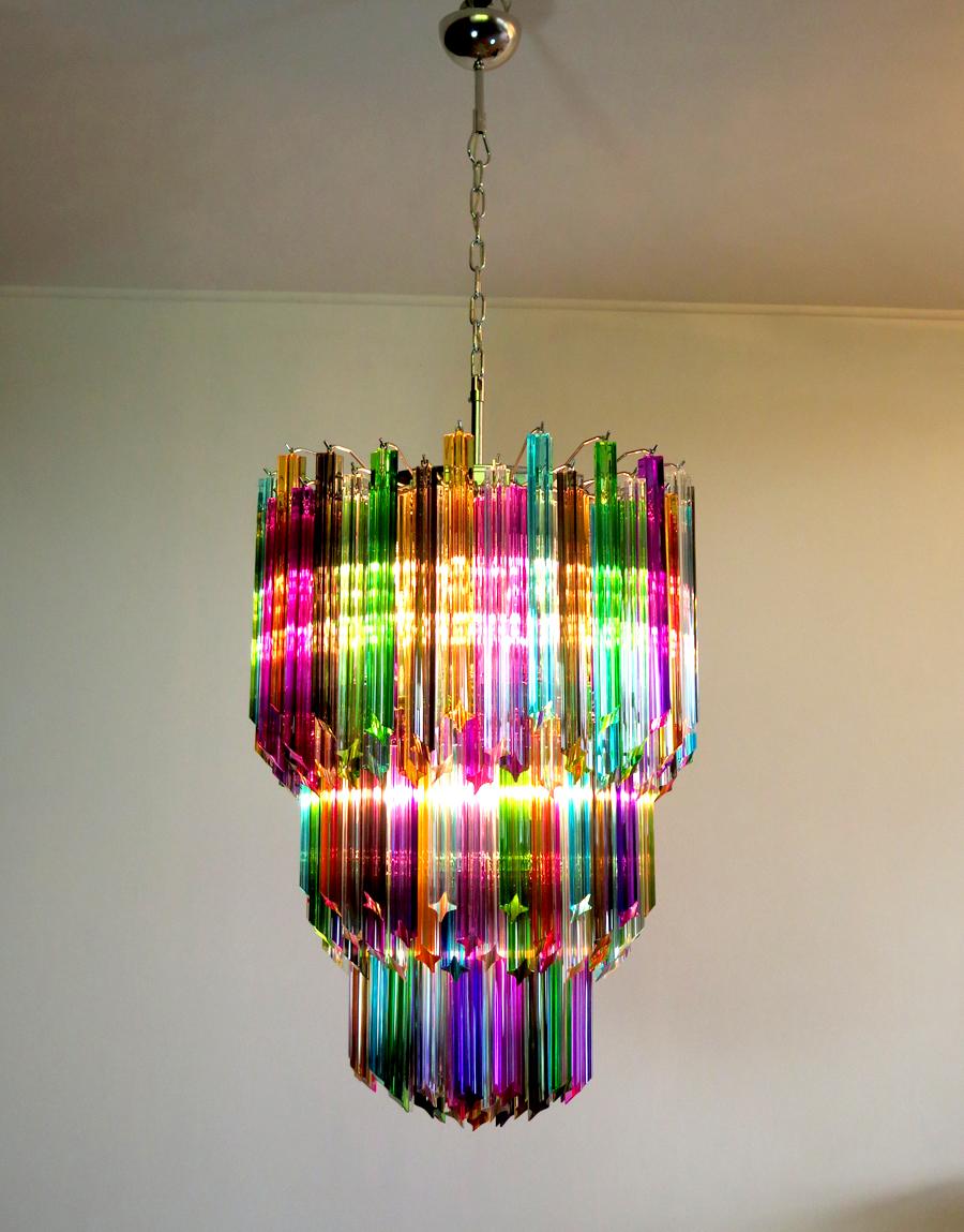 Fantastic vintage Murano chandelier made by 184 Murano crystal multicolored prism (QUADRIEDRI) in a nickel metal frame. The glasses are transparent, blue, smoky, purple, green, yellow and pink. The glasses have two different sizes.
Period: