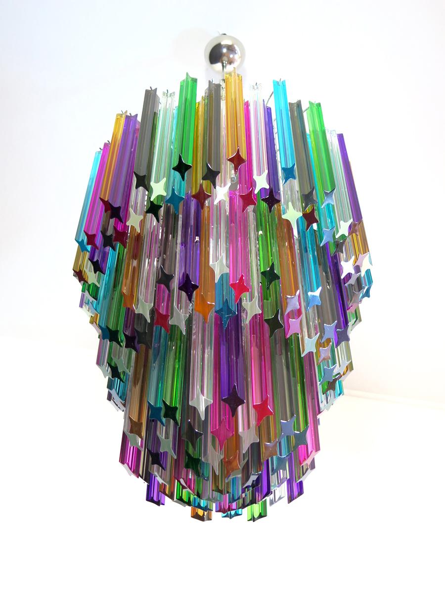 Fantastic vintage Murano chandelier made by 184 Murano crystal multicolored prism (QUADRIEDRI) in a nickel metal frame. The glasses are transparent, blue, smoky, purple, green, yellow and pink. The glasses have two different sizes.
Period: late XX