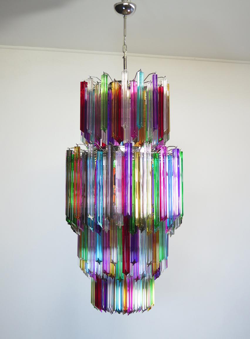 Fantastic vintage Murano chandelier made by 242 Murano crystal multicolored prism (QUADRIEDRI) on four levels in a nickel metal frame. The glasses are transparent, blue, smoky, purple, green, yellow and pink. The glasses have two different