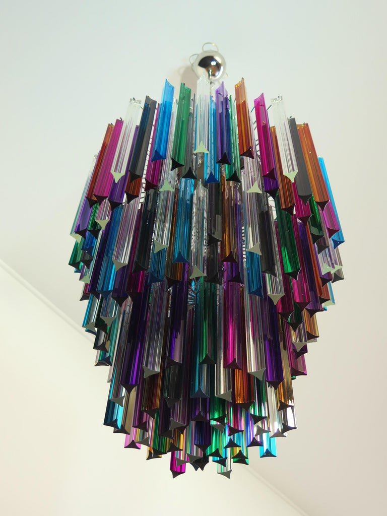Fantastic vintage Murano chandelier made by 187 Murano crystal multicolored prism in a nickel metal frame. The glasses are transparent, blue, smoky, purple, green, yellow and pink. The glasses have two different sizes.
Period:	late XX