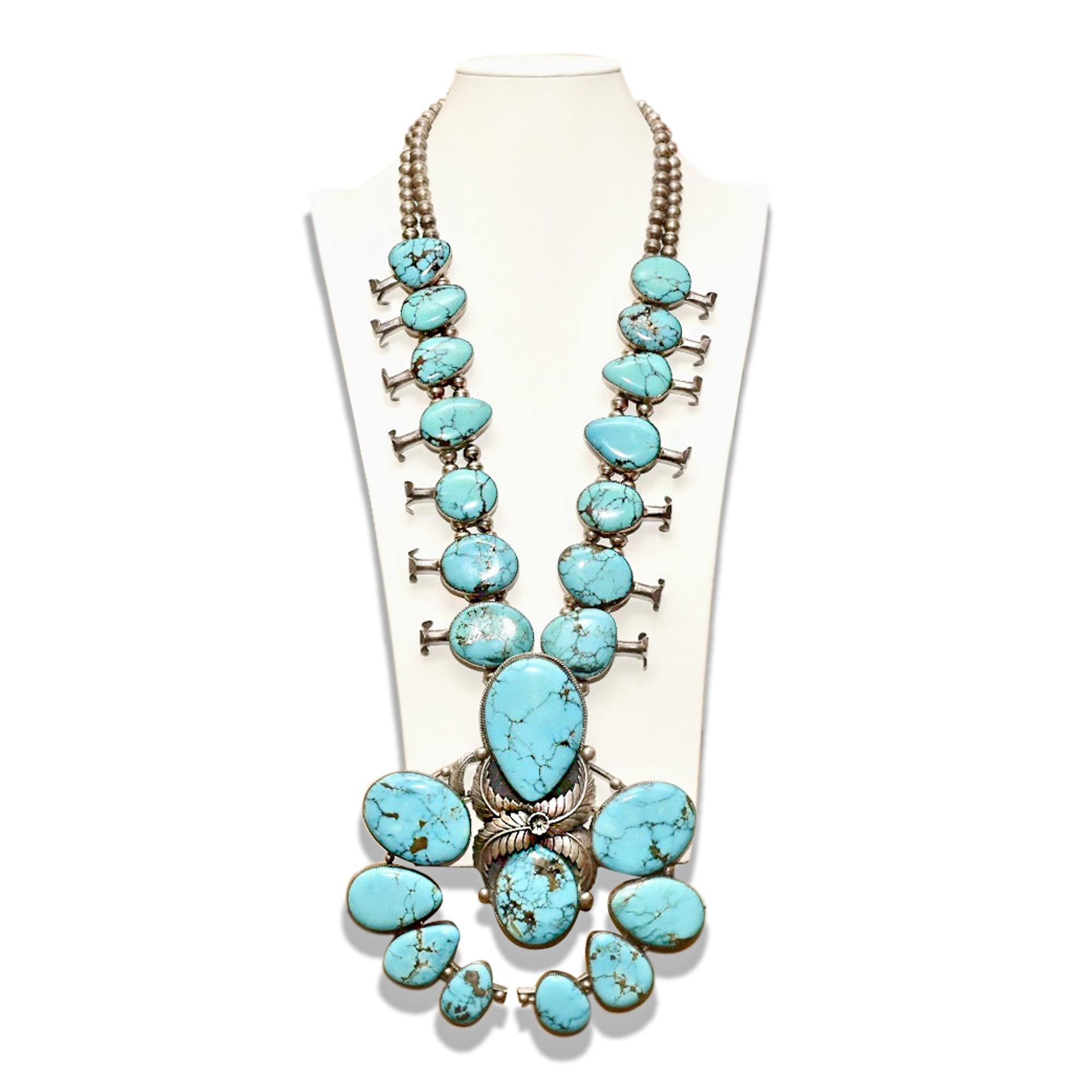 An incredible Old Pawn Native American squash blossom necklace with over 20 natural blue turquoise stones. Staggering in size and beauty, this necklace was most likely designed for a ceremonial powwow and looks like a museum-quality display piece.