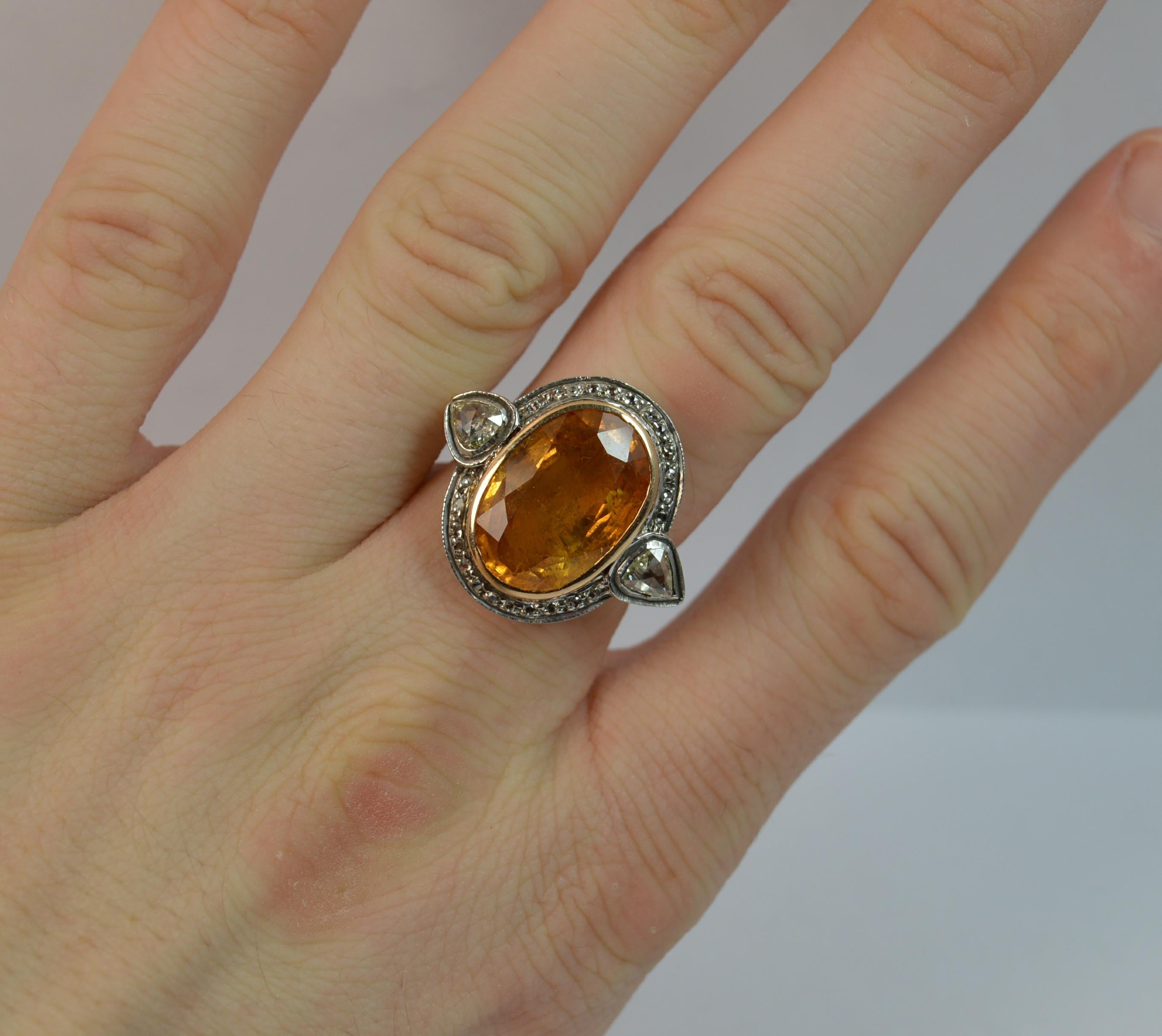 

A stunning and very rare orangish yellow sapphire and diamond ring.

Modelled in 14ct yellow gold with a white gold head setting.

Designed with a large oval cut natural sapphire to centre, 11mm x 16mm approx.

To each side are pear shaped rose