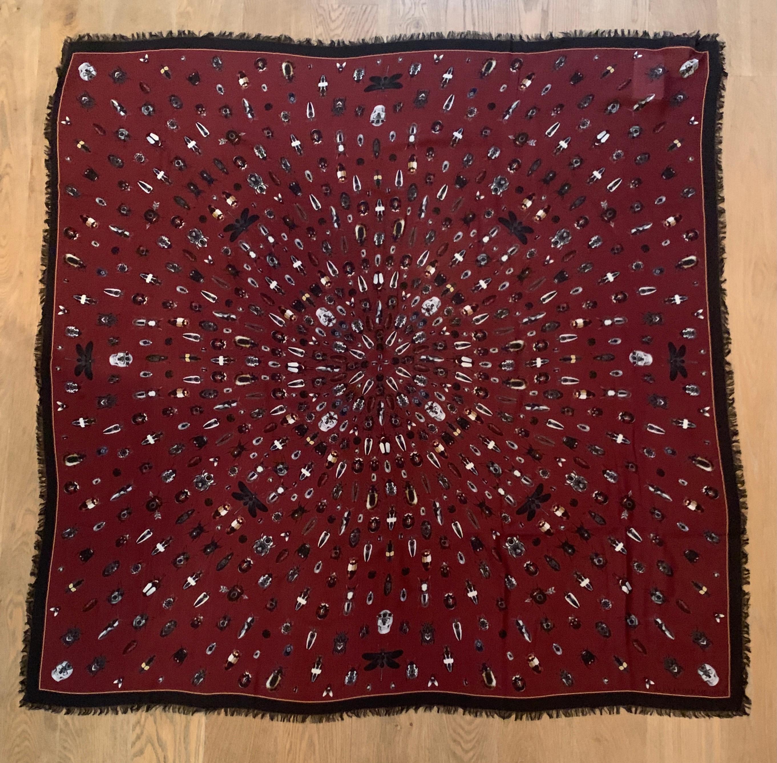 New Alexander McQueen large burgundy red and black scarf featuring insects and small skulls throughout. Dragonflies, beetles, flies and more, some adorned in a jewel print! Fringed edges.

Large size makes it great for a sarong or pool cover up!