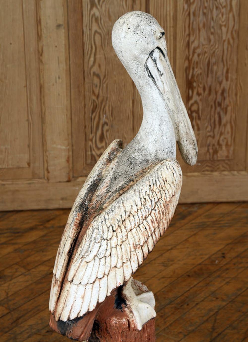 A large master work in stone for the finest patio, garden, or seascape setting

A fine large scale pelican perched on top of a stump and hand cast and hand painted with good details possessing original old patina from age. 

They do not come