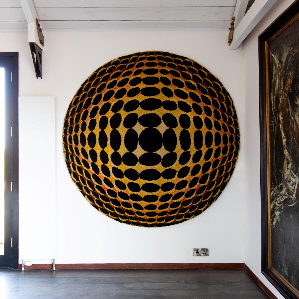 A huge circular Optical Art wool woven wall sculpture panel, 1970s

During the 1960s Op Art or Optical Illusion Art burst onto the scene drawing on colour theory and the physiology and psychology of perception. The effects created by op art ranged
