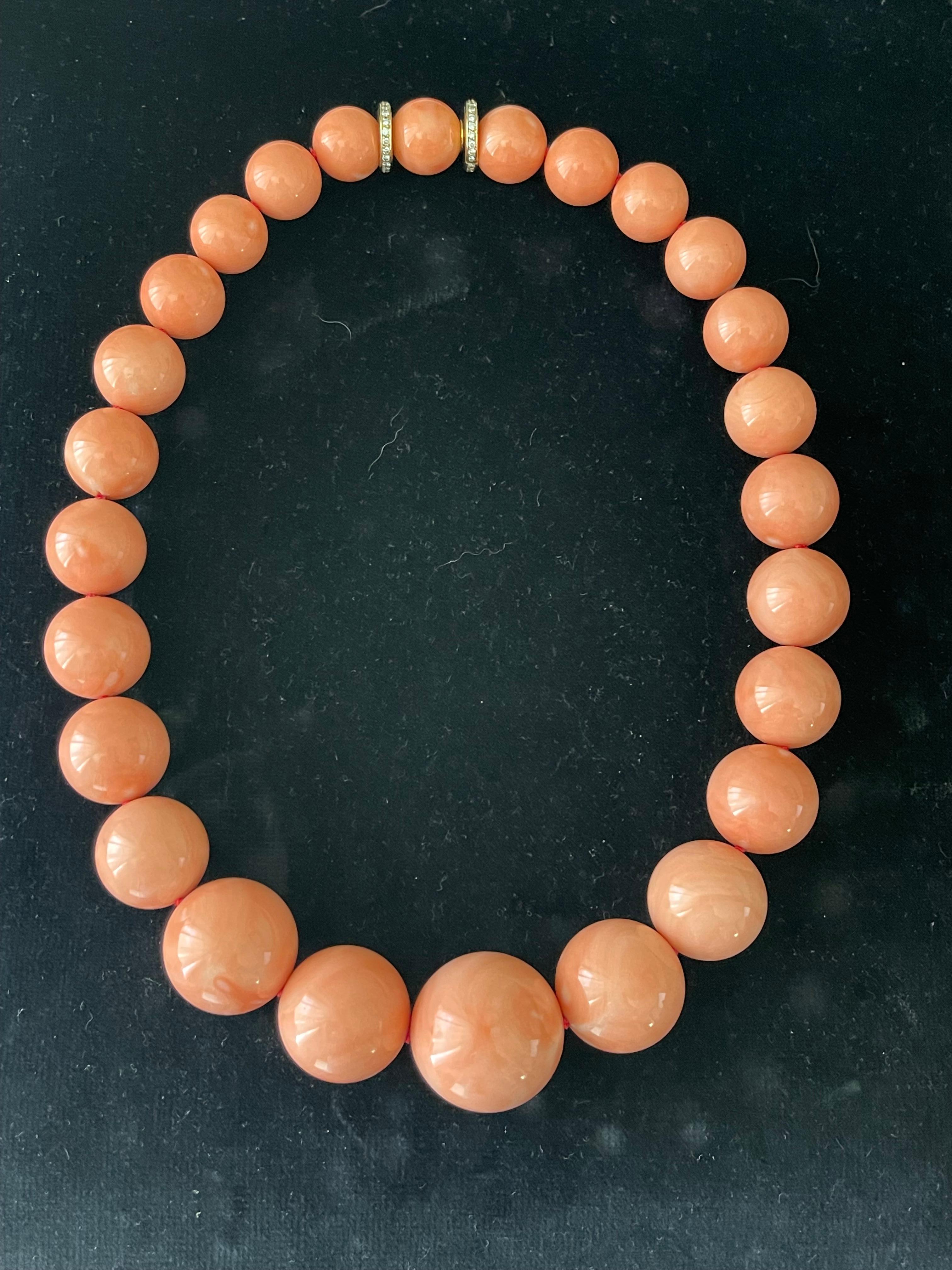 Beautiful and impressive  coral bead necklaces with 18 K yellow Gold Diamond clasp signed Sabbadini. The necklace with a length of 48 cm has a total of 26 coral beads graduating from 13.80-18.10-25.65-18.10-14.45 mm. 
The overall condition of this