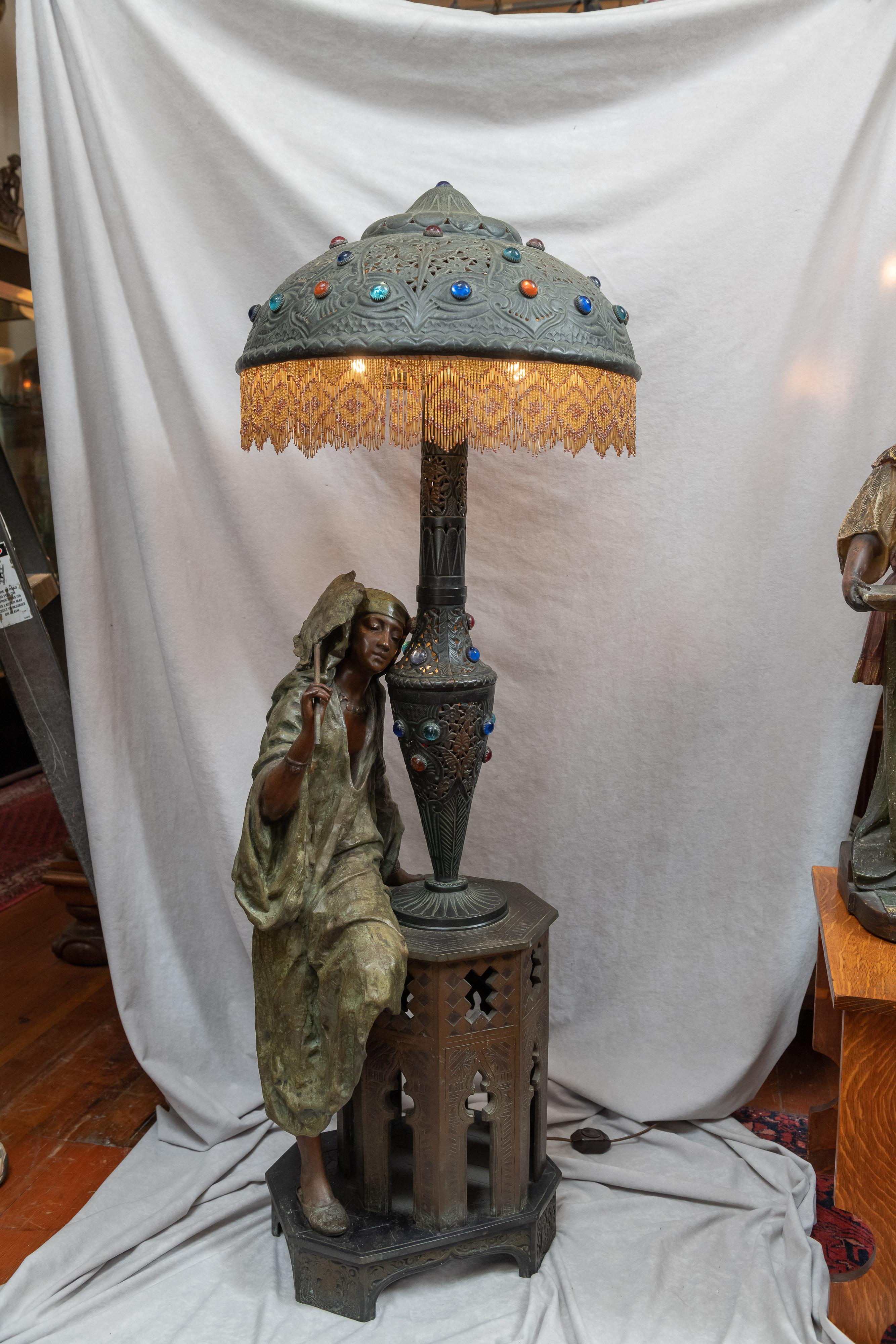 This lamp is nothing short of remarkable. I have only seen a few of this size and genre in all my 46 years of having an antique shop. The few that survived that are lamps would certainly be lacking the shade. A young attractive Arab woman beside a