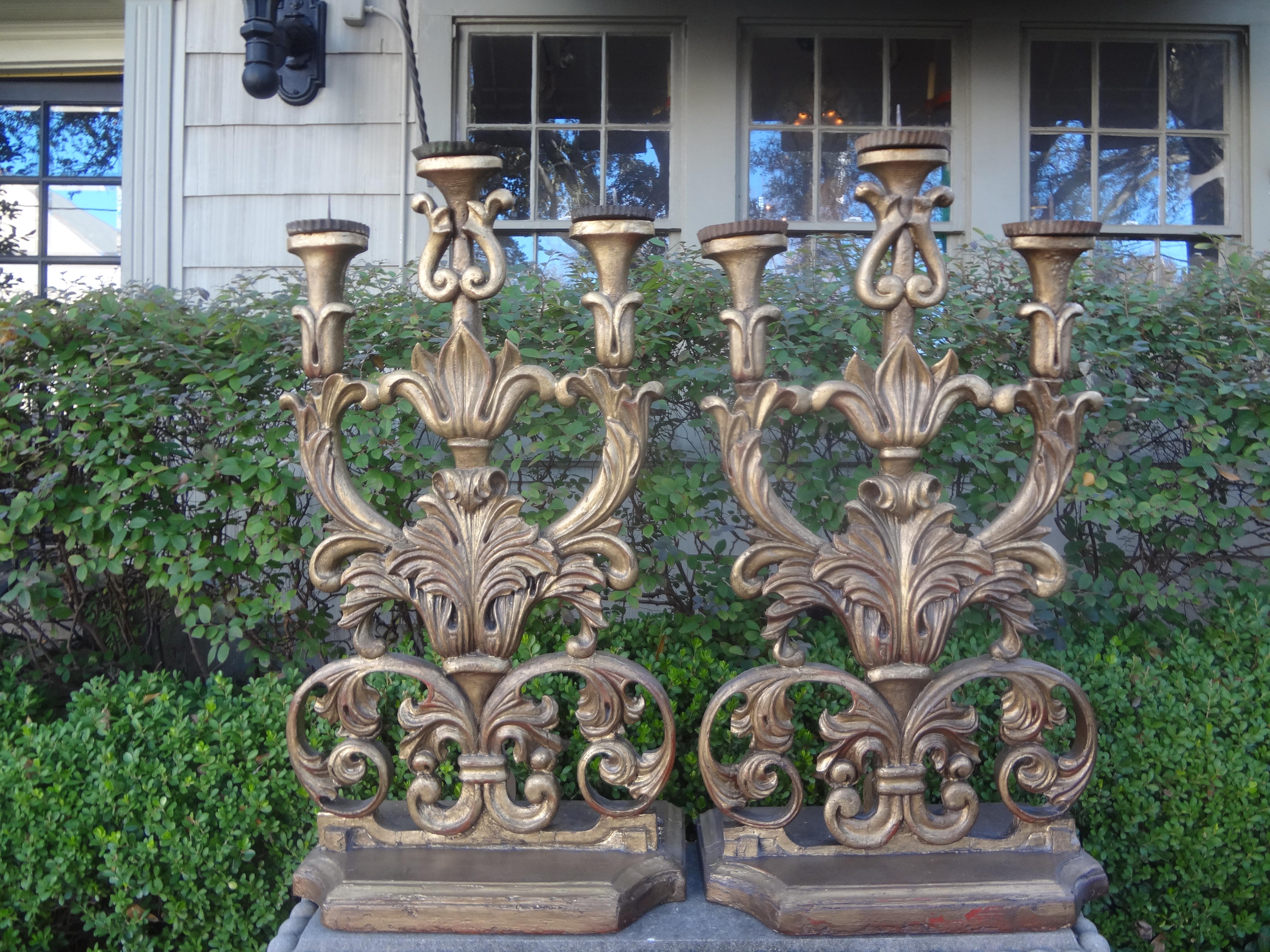 Magnificent pair of 18th century Italian Baroque giltwood altar candelabra. This stunning huge pair of Italian Baroque gilt wood pricket altar sticks, candlesticks or candleholders will be the focal point of a mantel, console table, credenza or