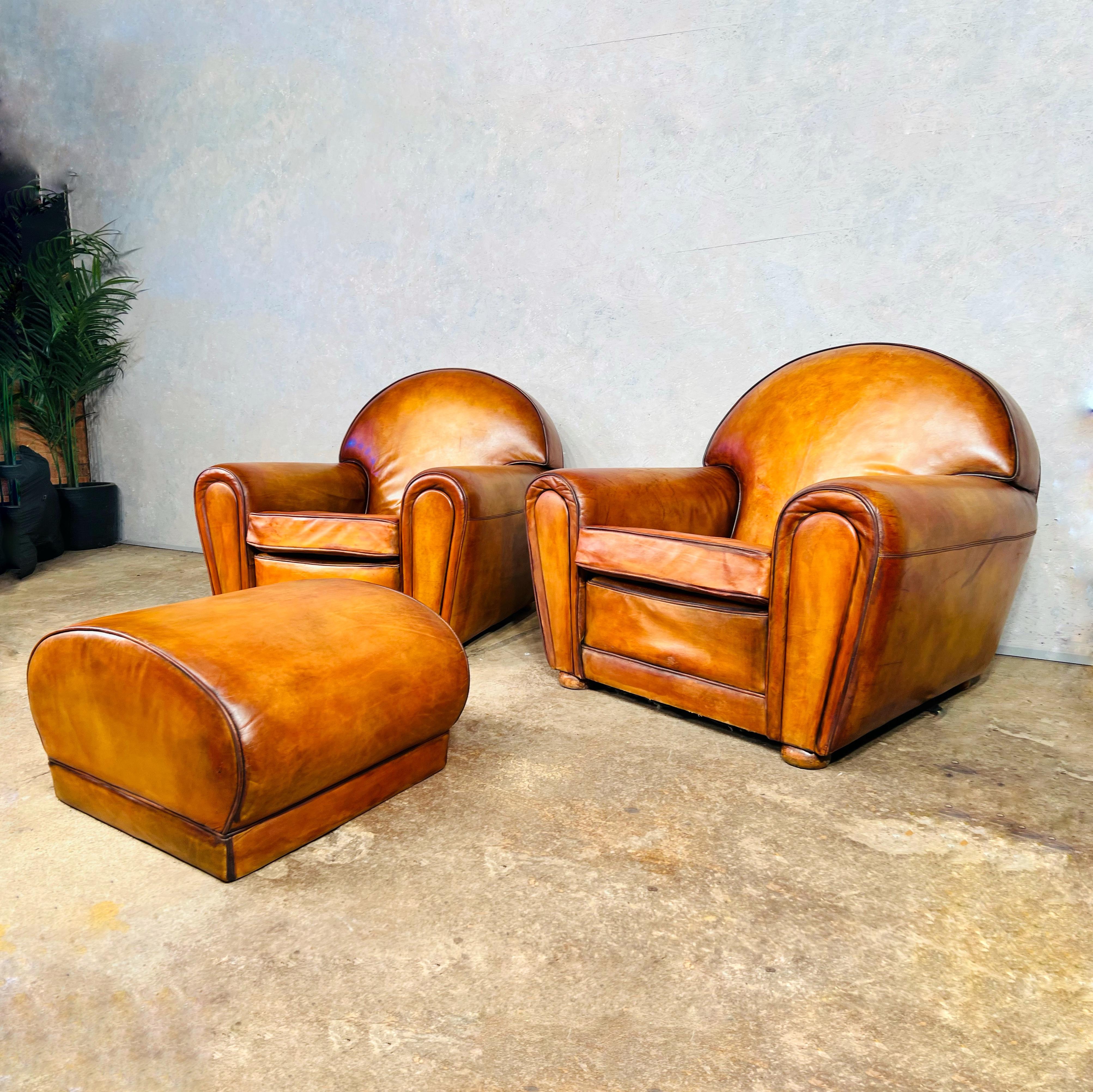 An Exceptional huge pair of Art Deco leather club chairs armchairs and foot stool 1940s.

Beautiful hand dyed light tan colour with exceptional patina and finish.

Viewings welcome at our showroom in Lewes, East Sussex.

